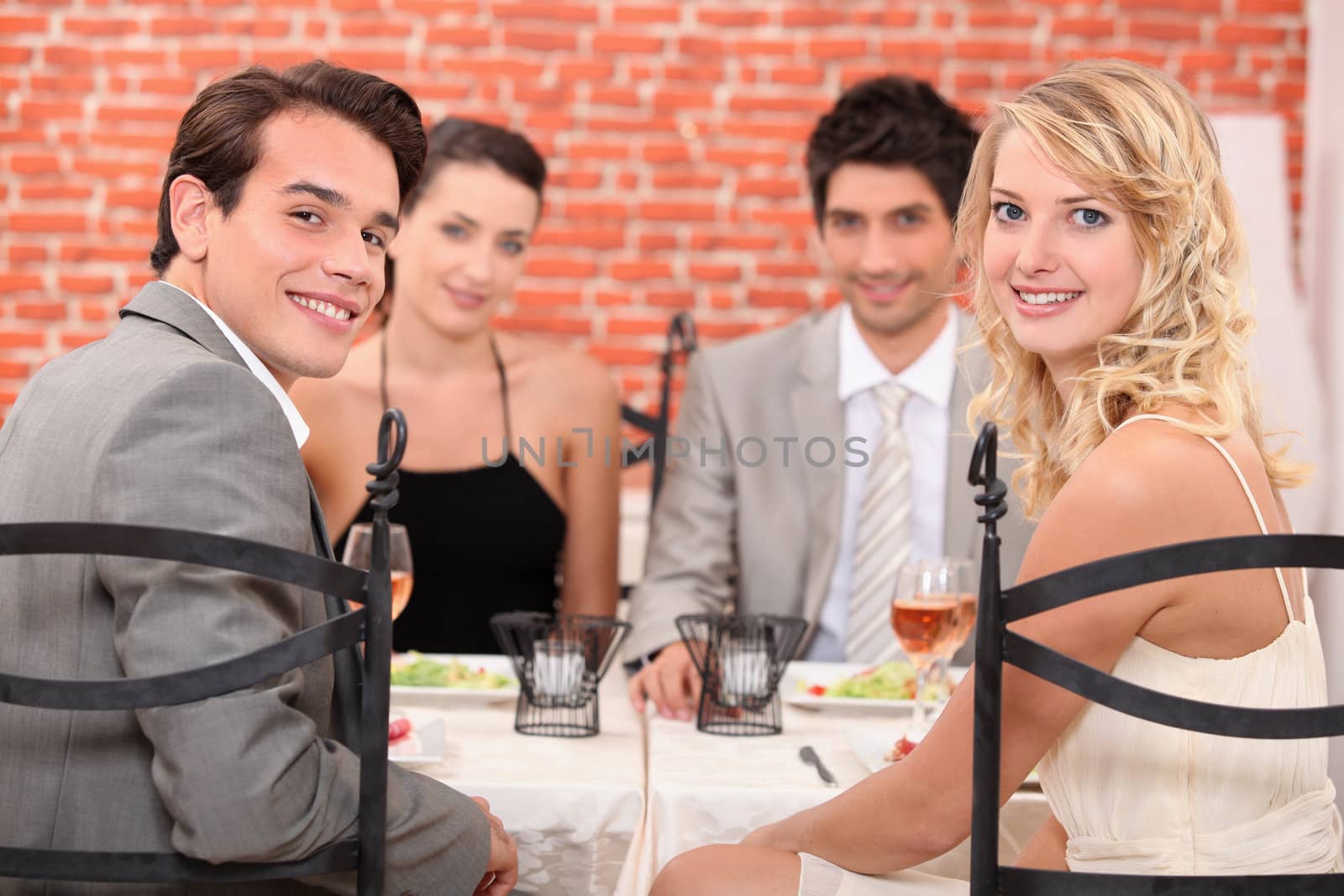 Group of friends at the restaurant by phovoir