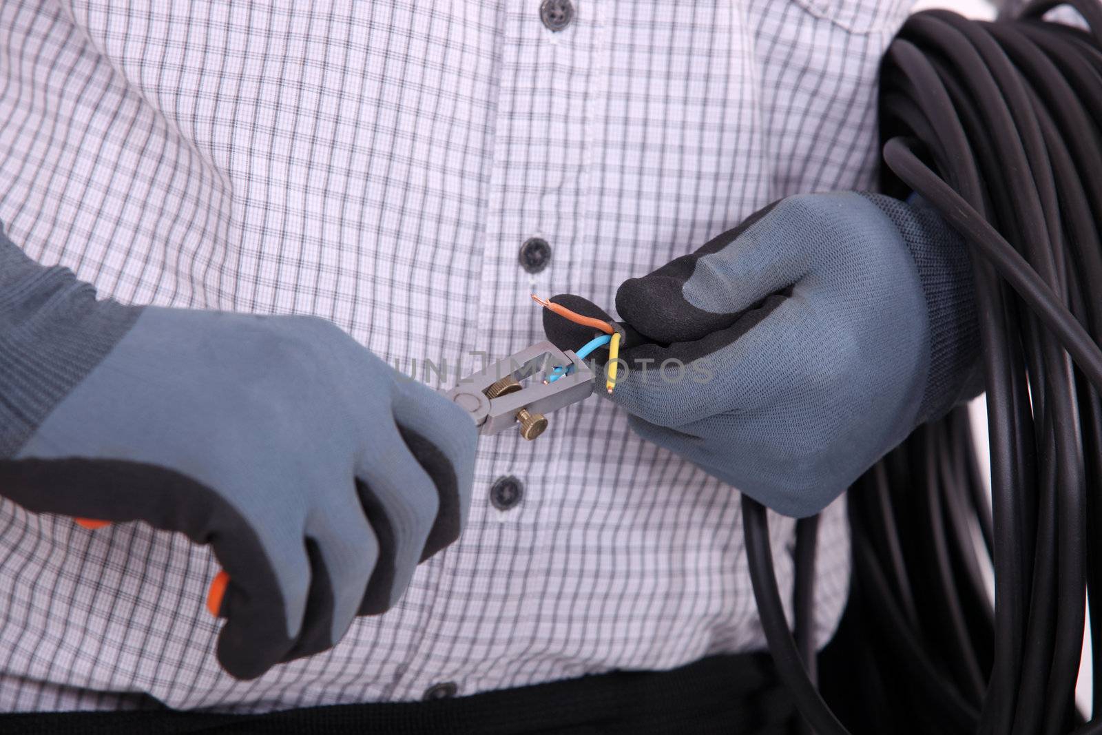 close-up on gloved hands of electrician at work