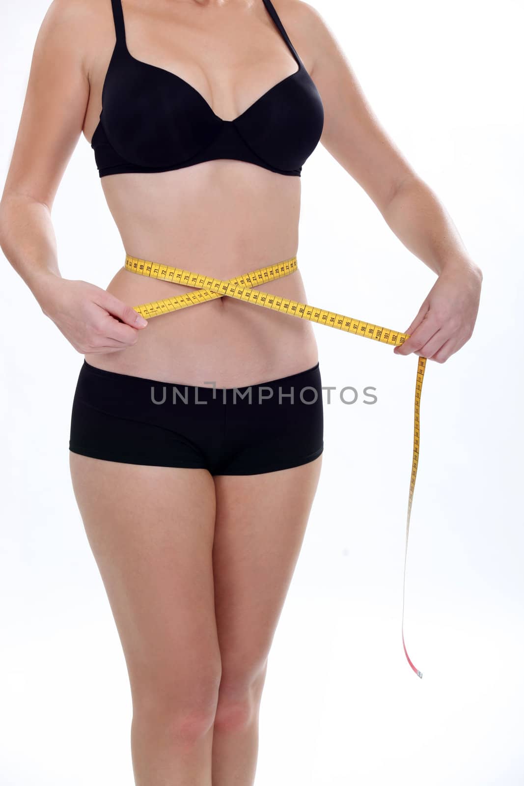 Woman measuring her waistband by phovoir