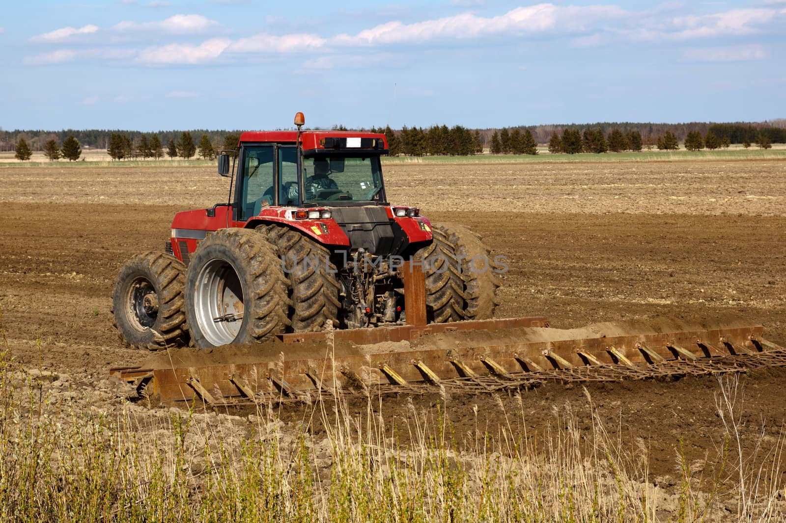 Tractor cultivated field in early spring
