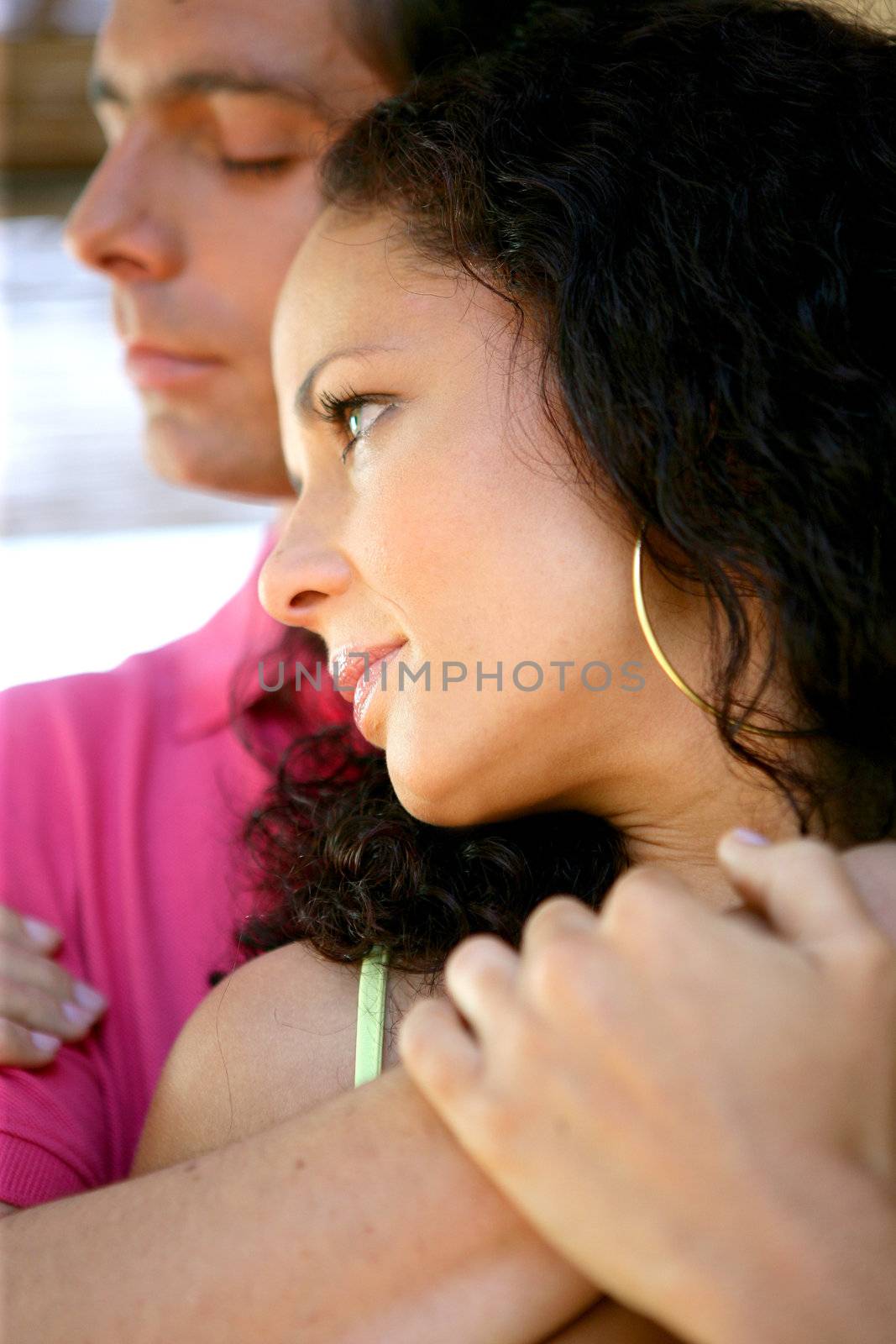 Young couple in a restful embrace by phovoir