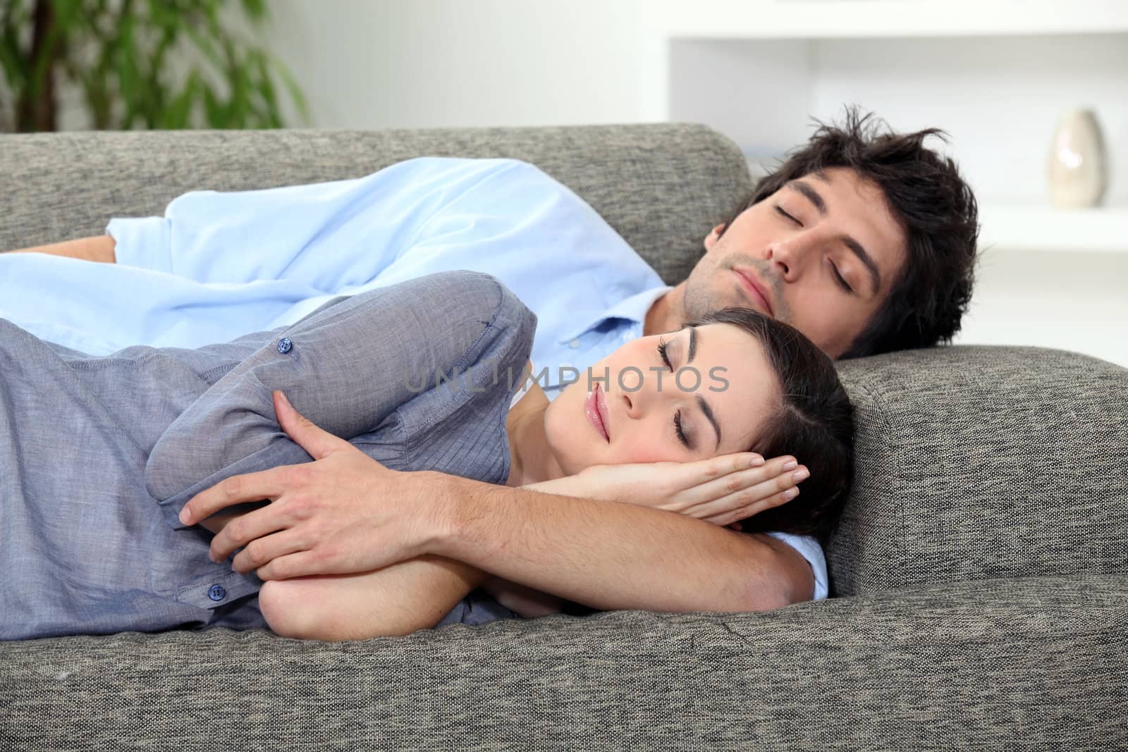 Couple asleep on sofa