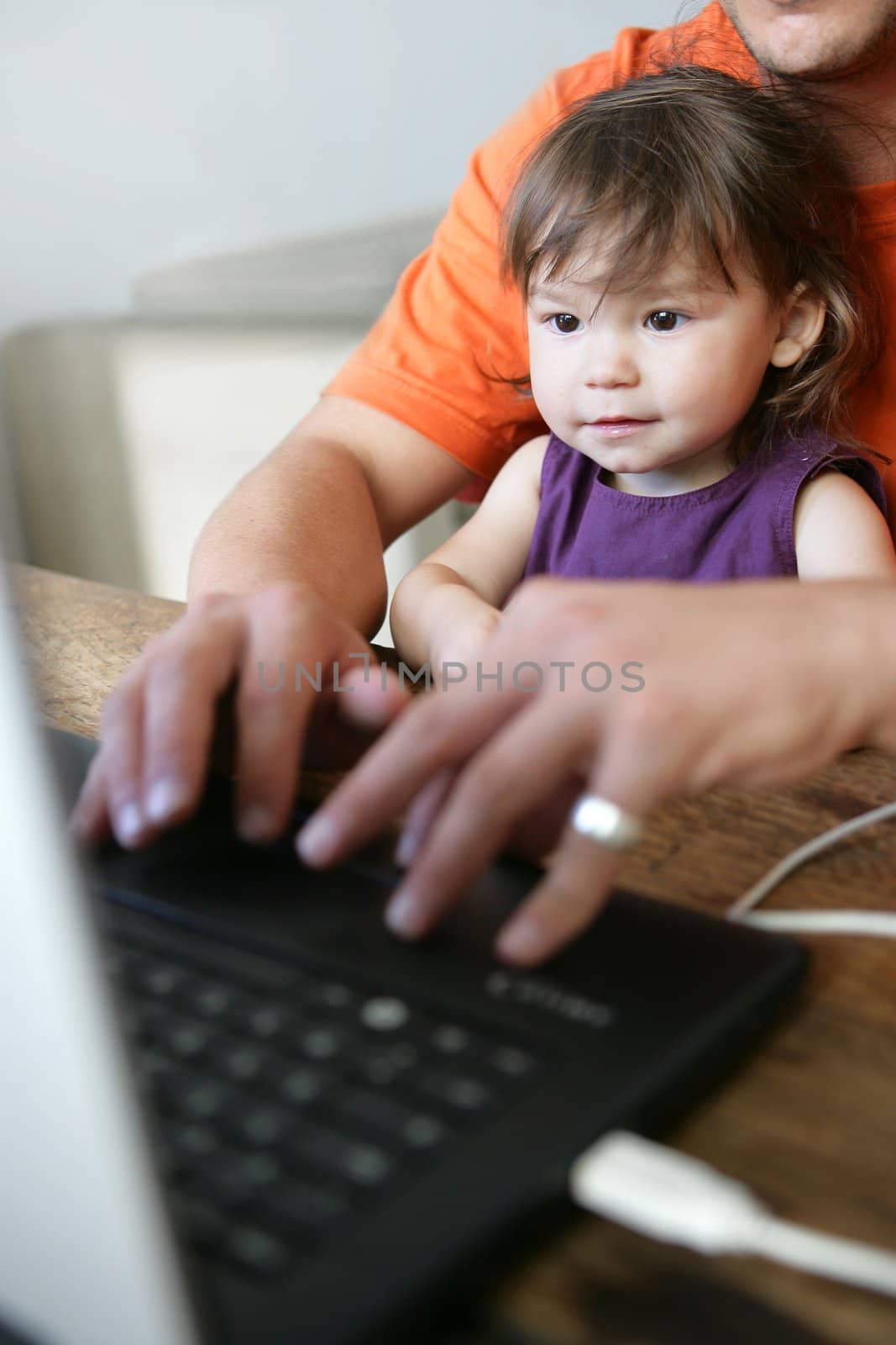 Father and daughter using computer by phovoir