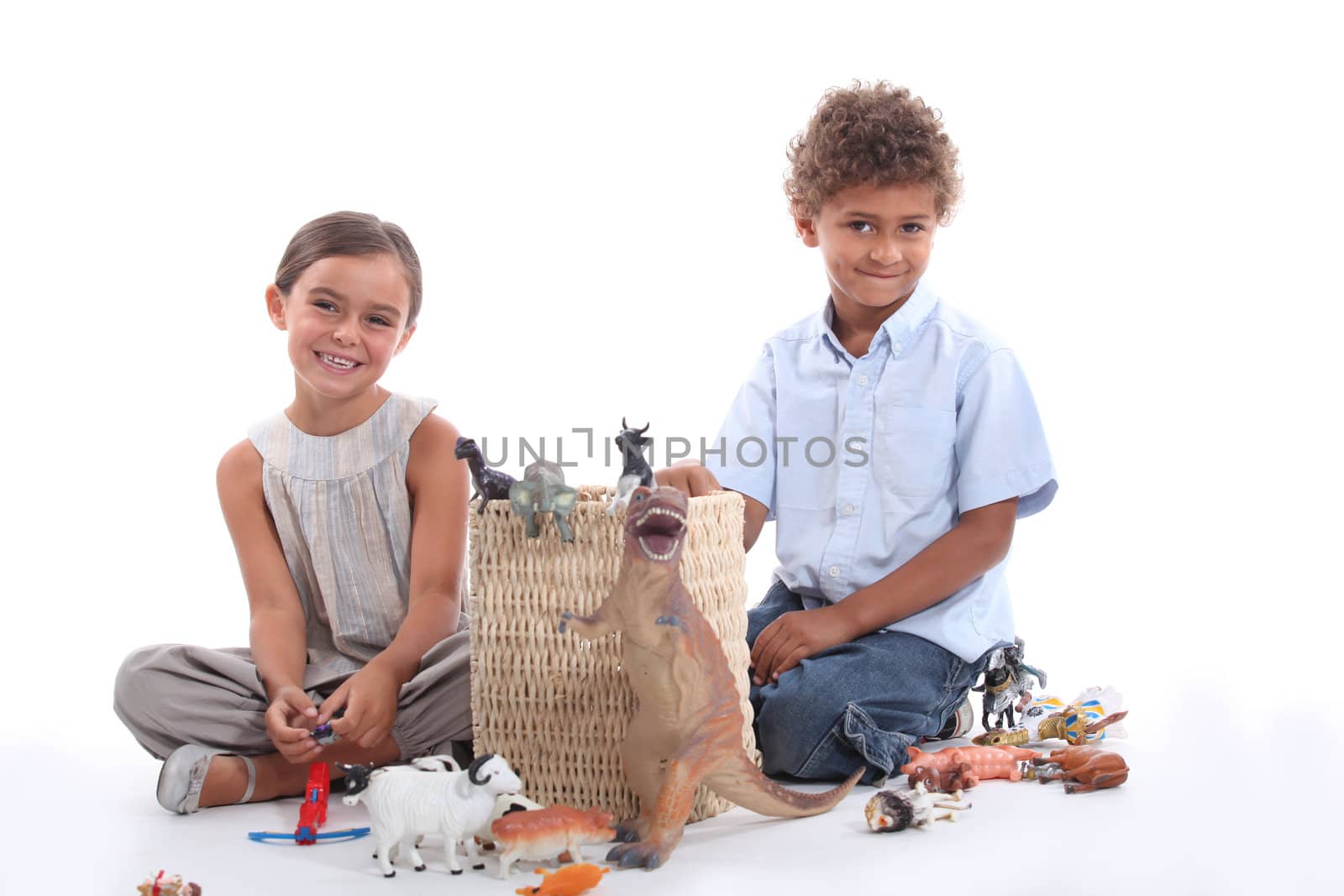 Children playing with plastic toy figurines