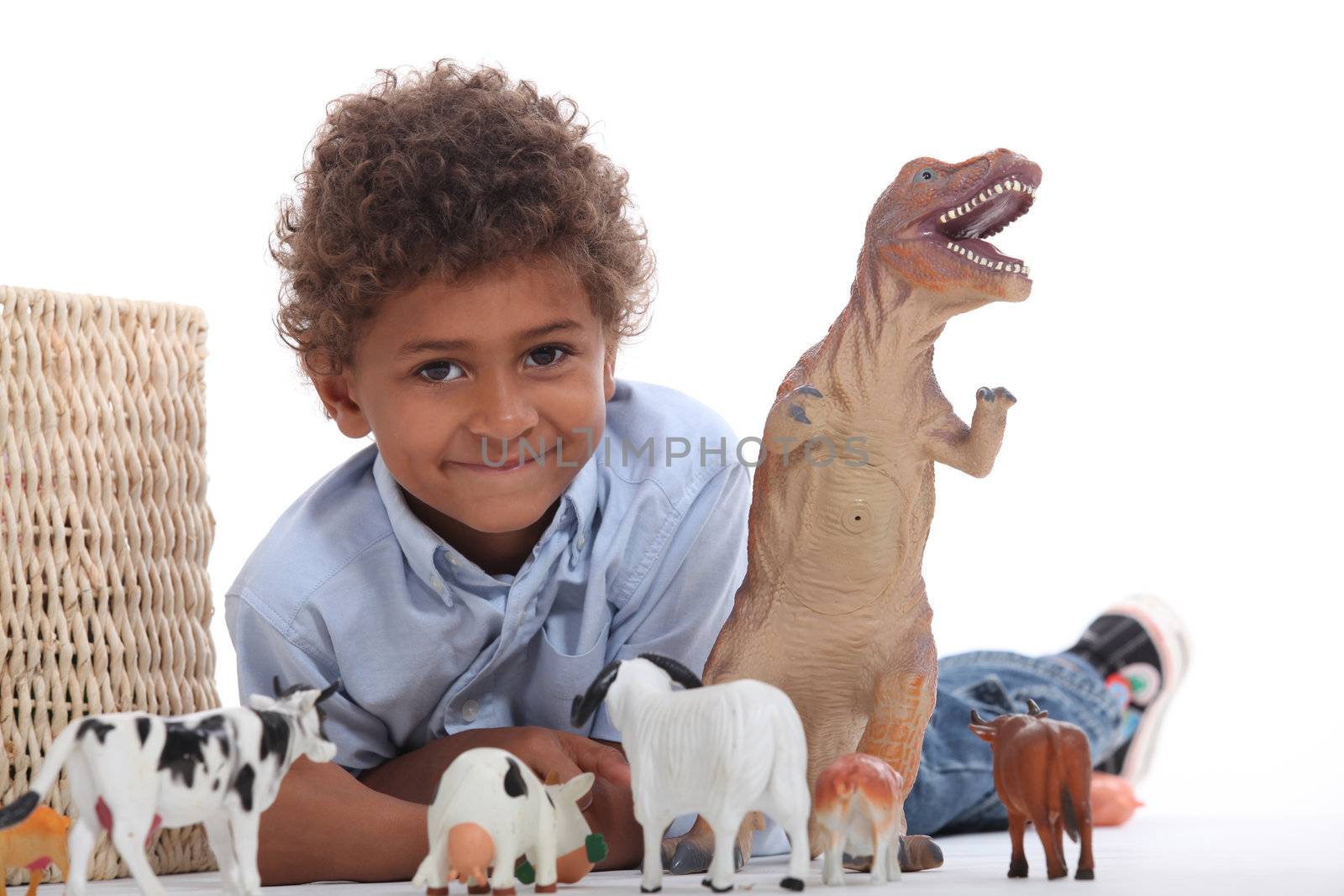 Young boy with his toy animals