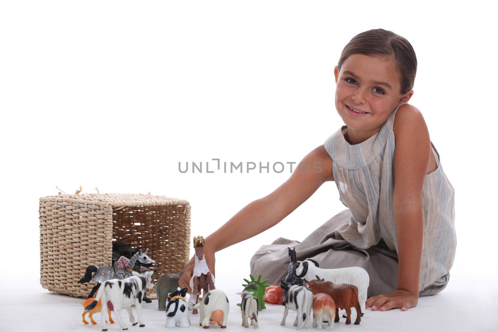 Little girl playing with toy animals