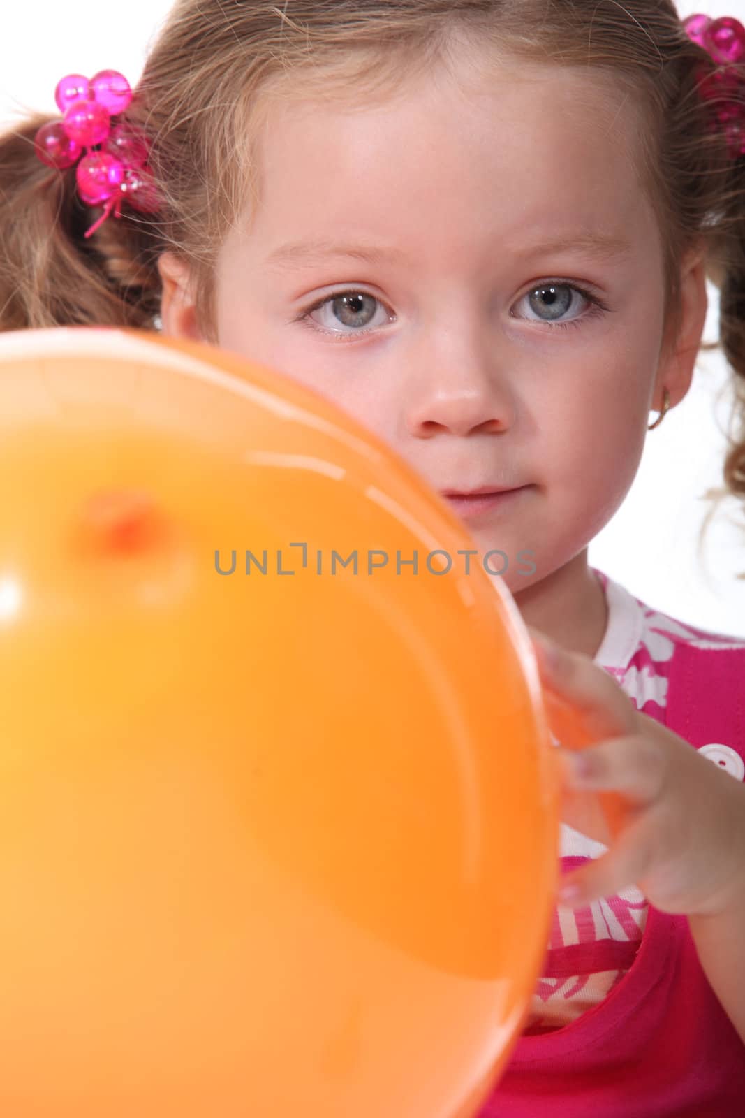 little girl holding a balloon by phovoir