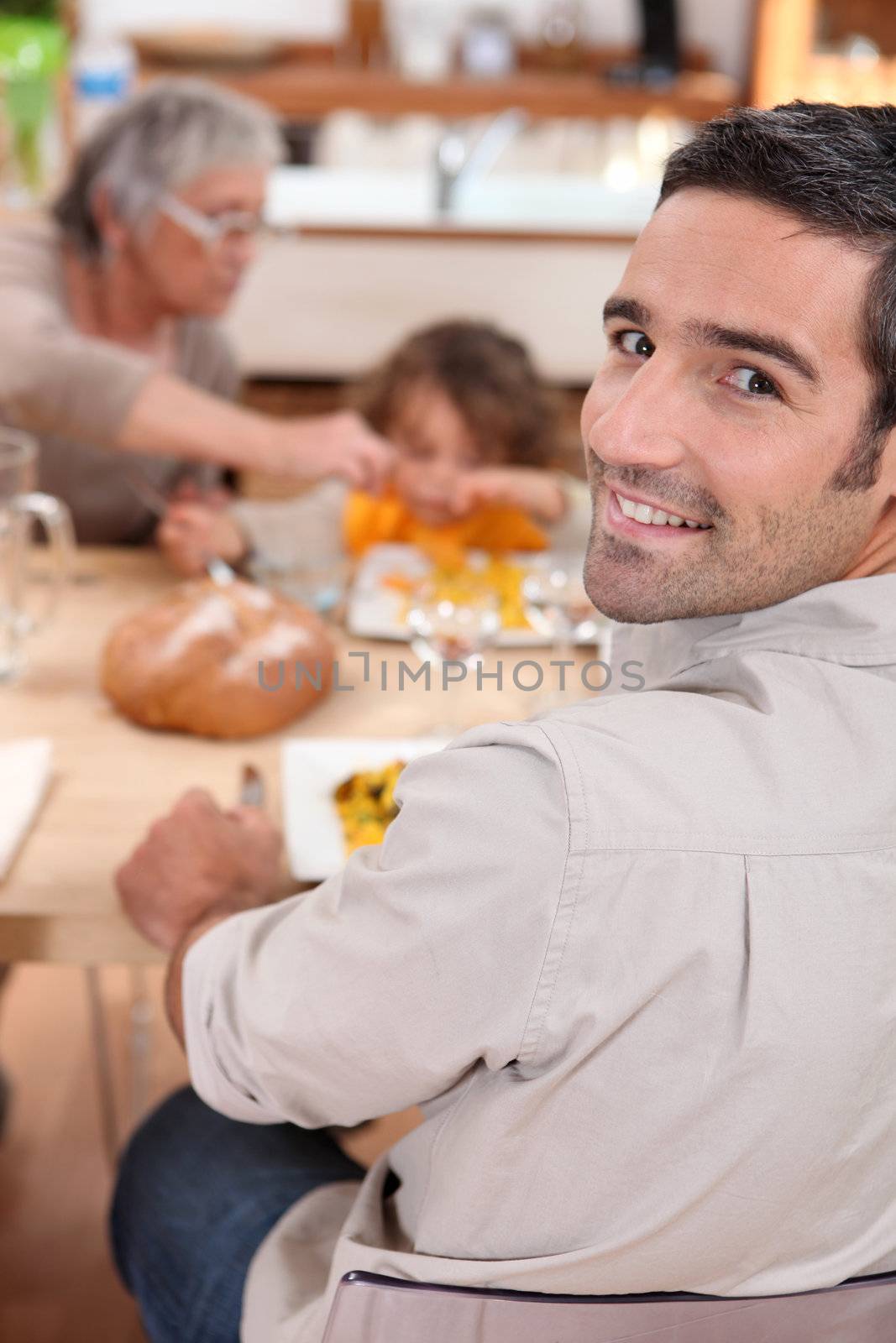 Family having meal in kitchen