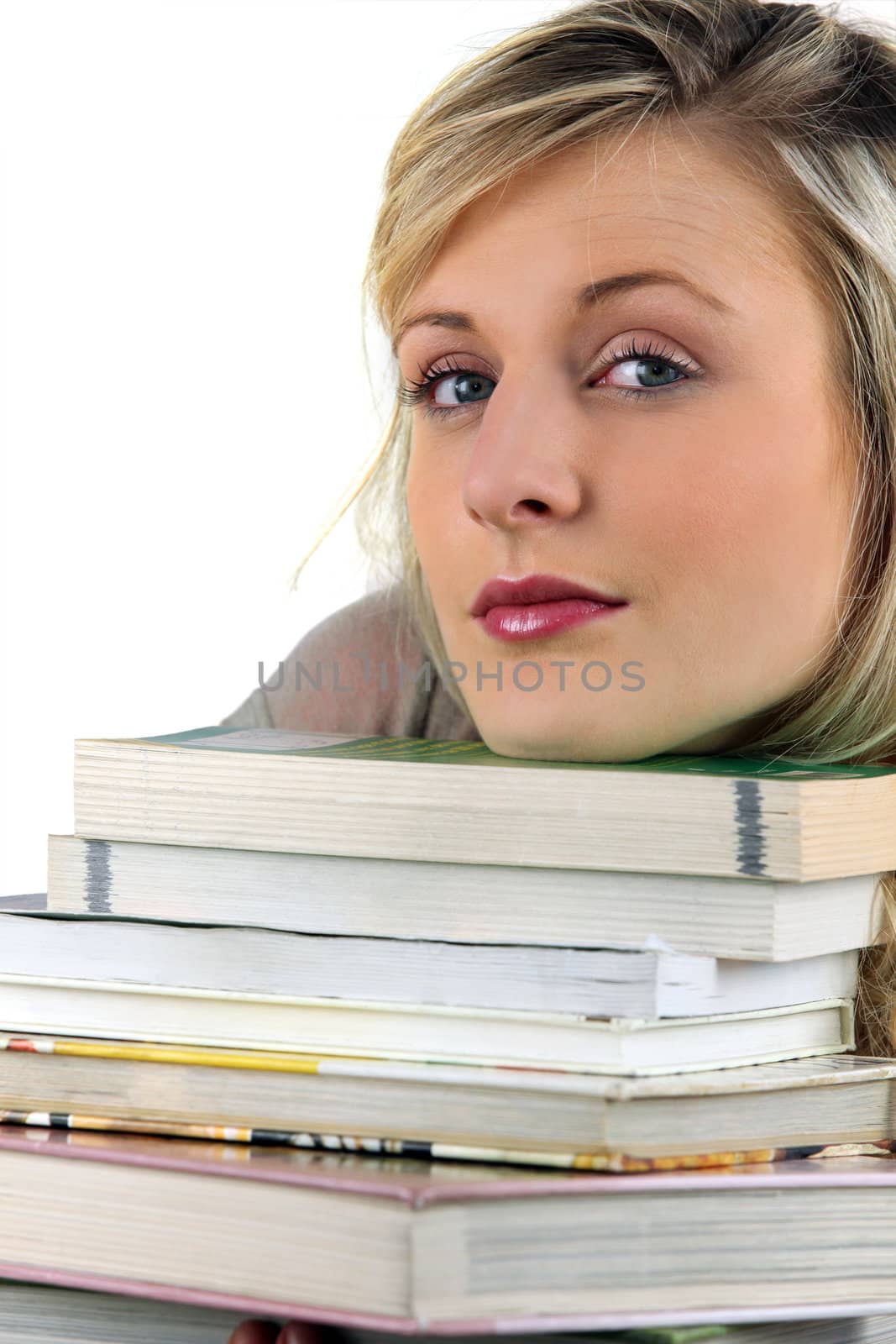 Young woman with a stack of books by phovoir