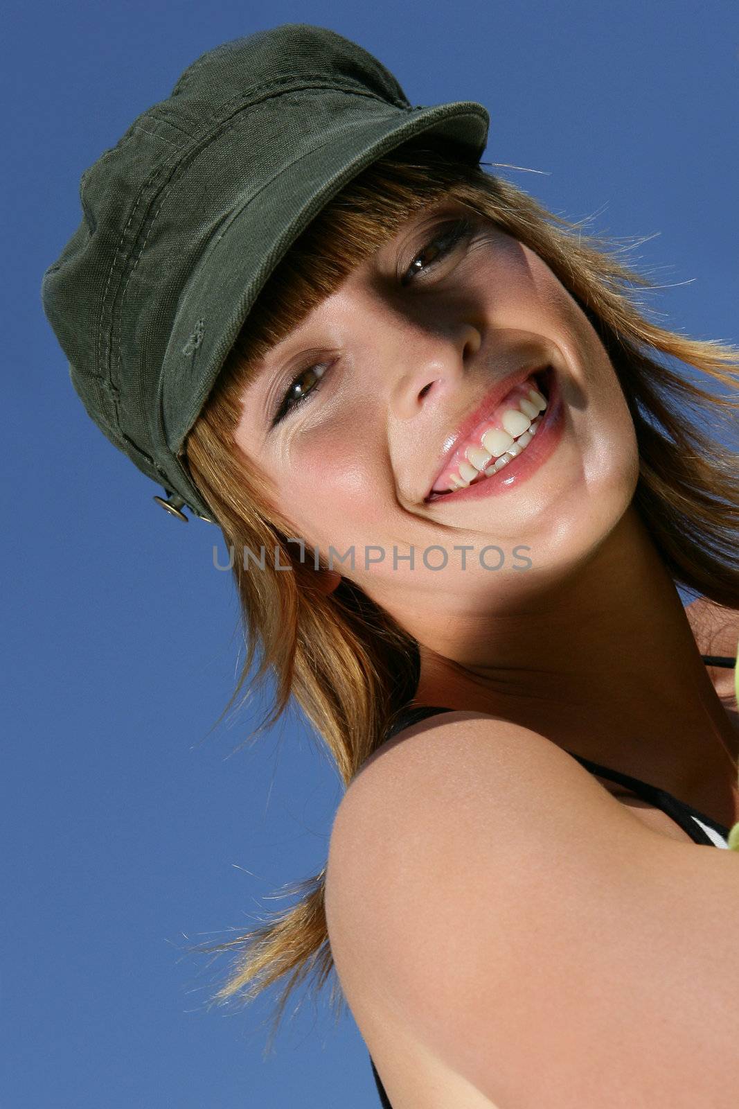 Woman wearing a hat outdoors by phovoir