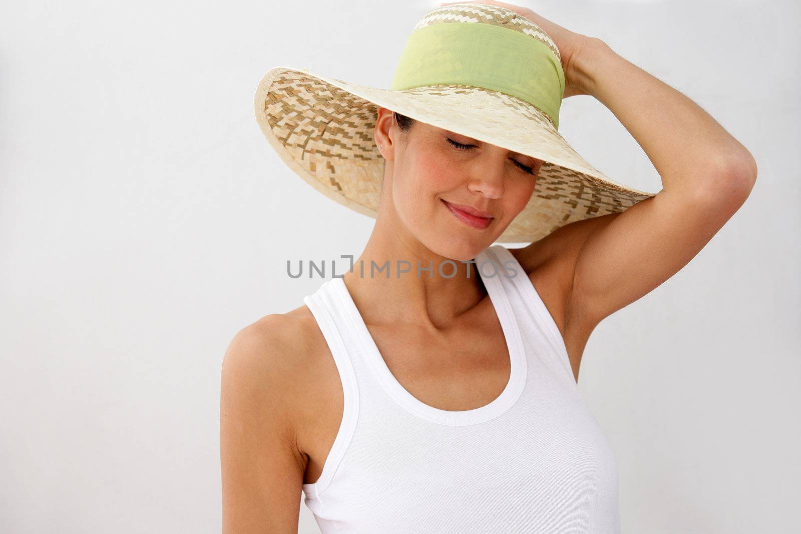 Brunette wearing straw hat by phovoir