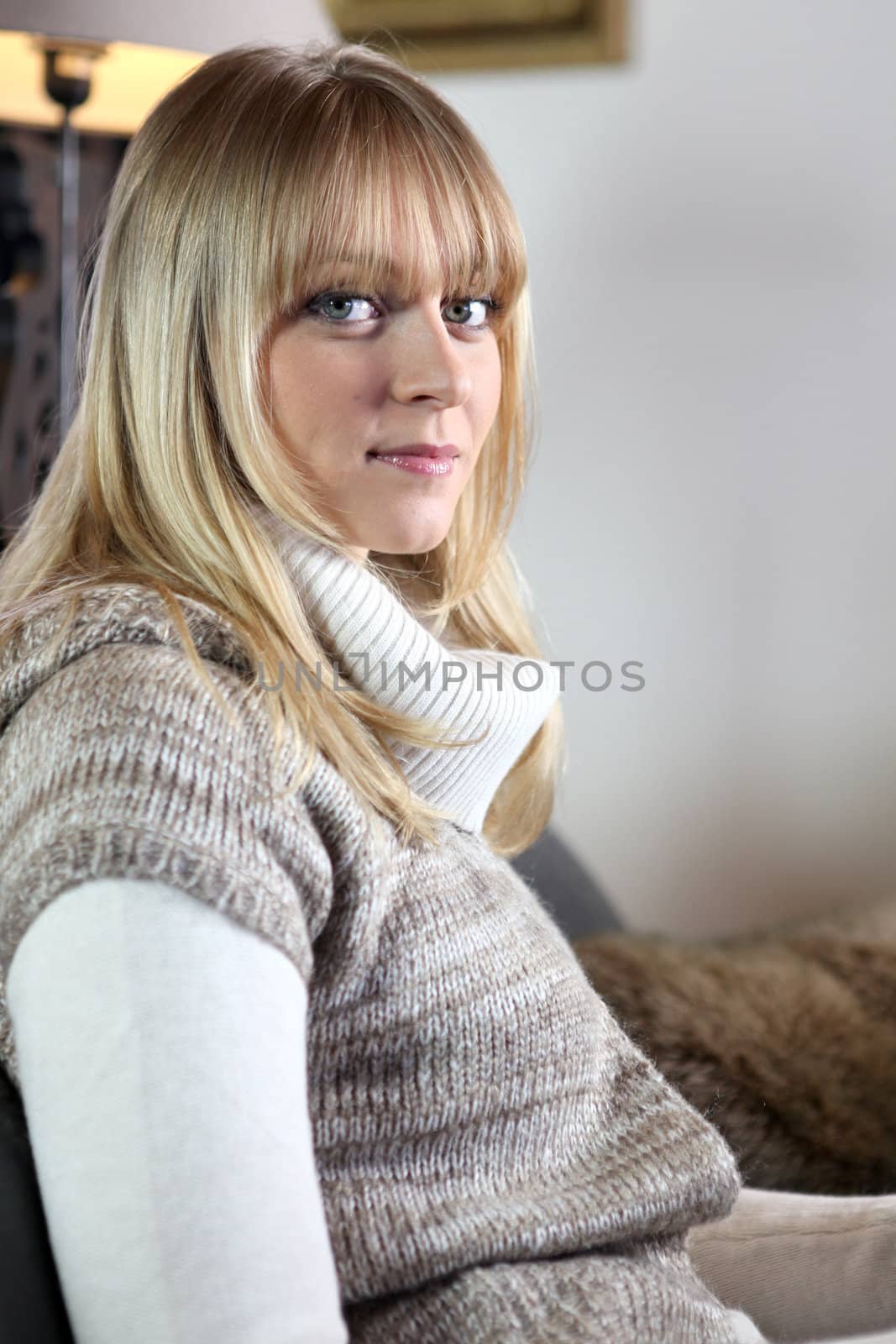 Attractive blond relaxing on sofa by phovoir