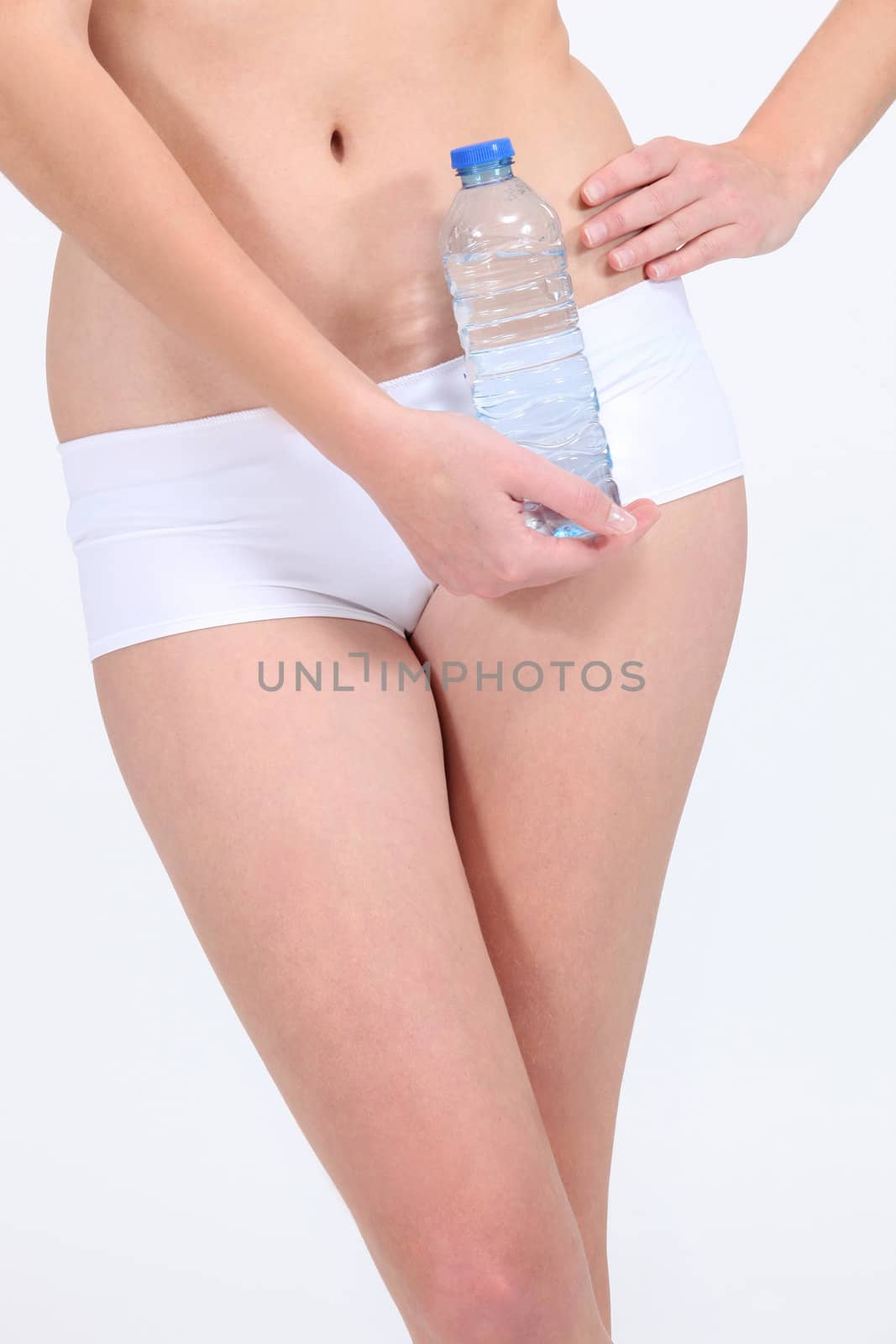 Woman in underwear holding water bottle by phovoir