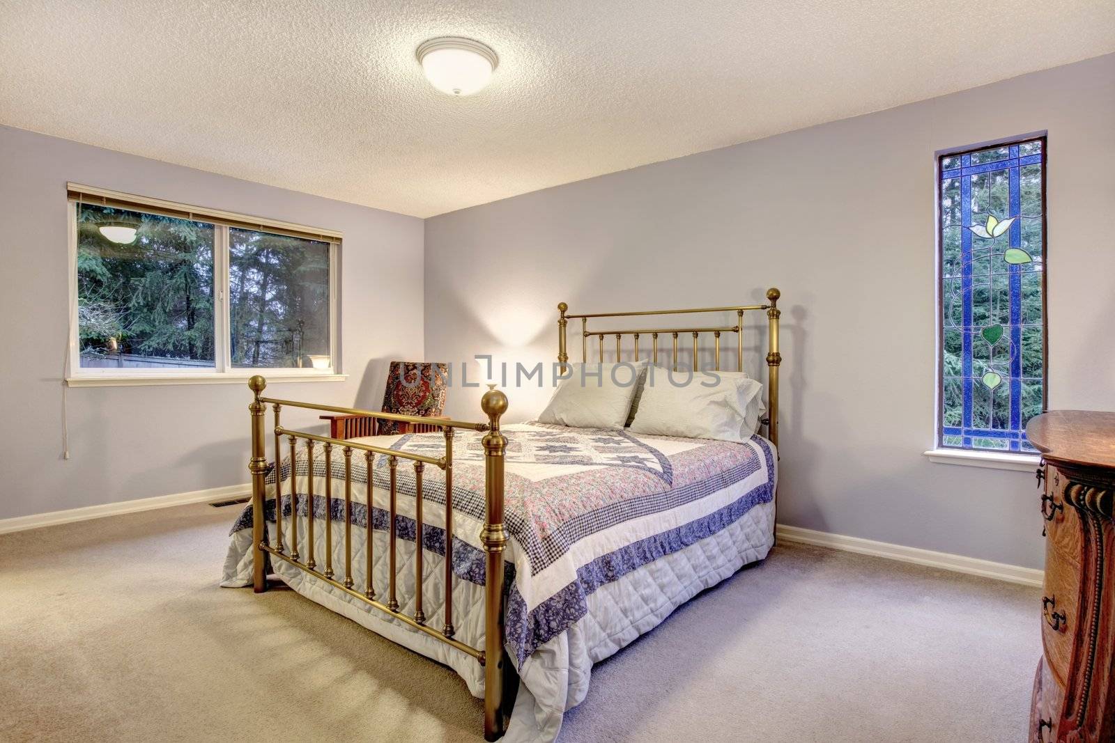 SImple blue bedroom with metal bed.