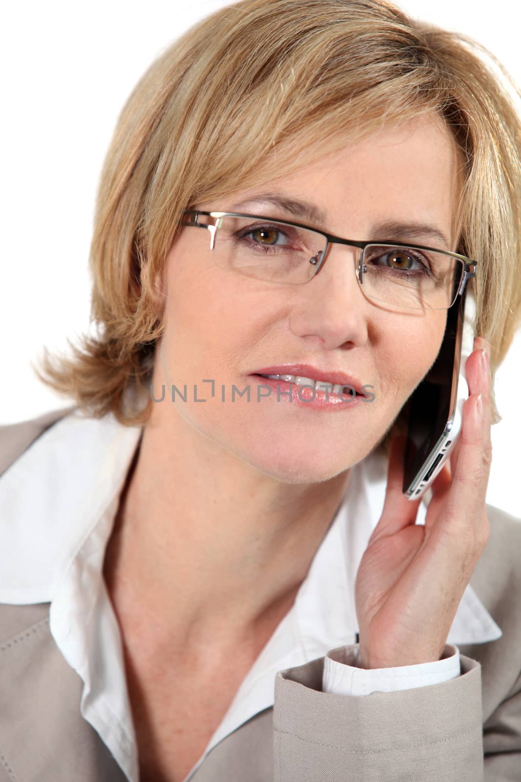 Woman listening to her cellphone by phovoir