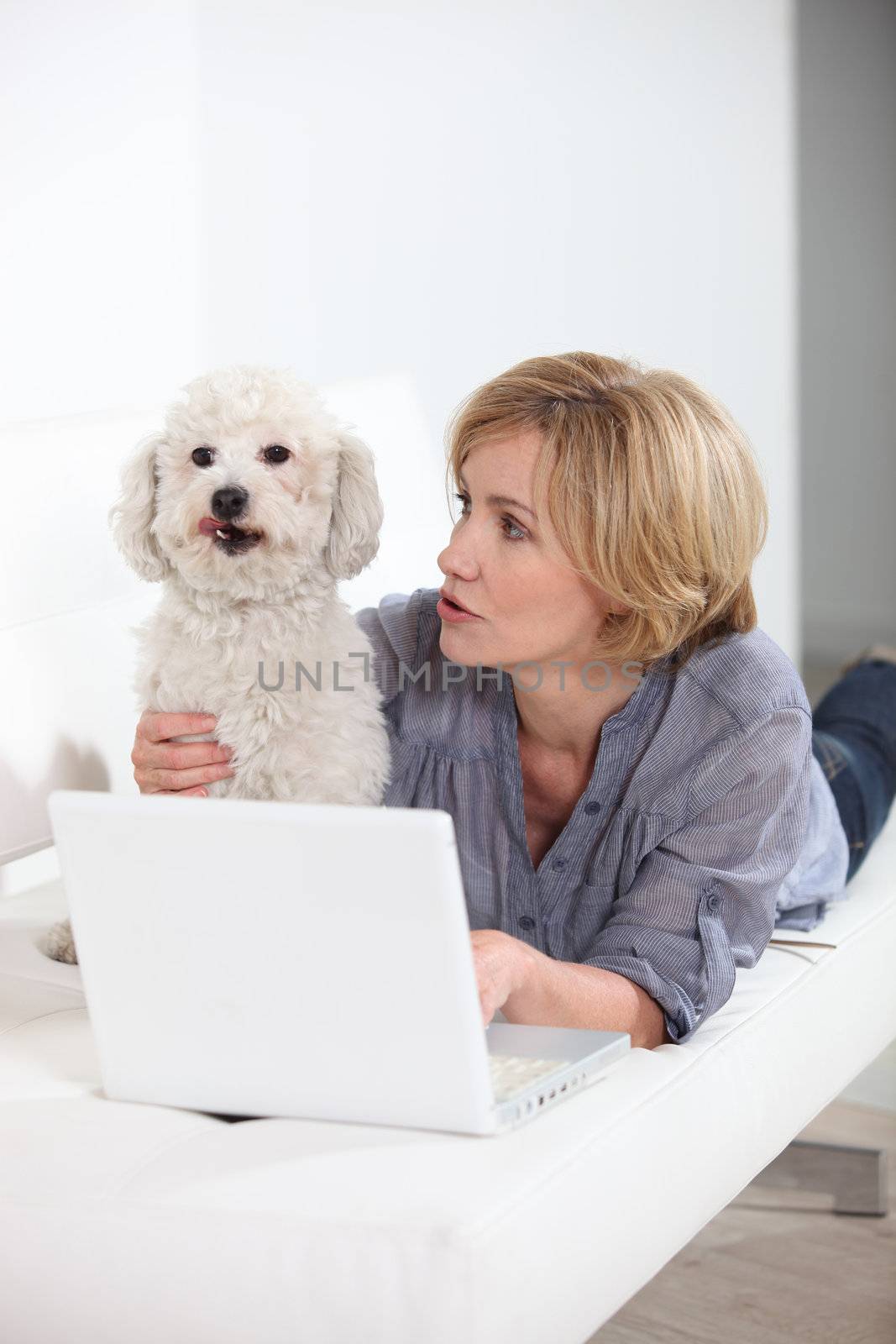 woman with laptop and dog by phovoir