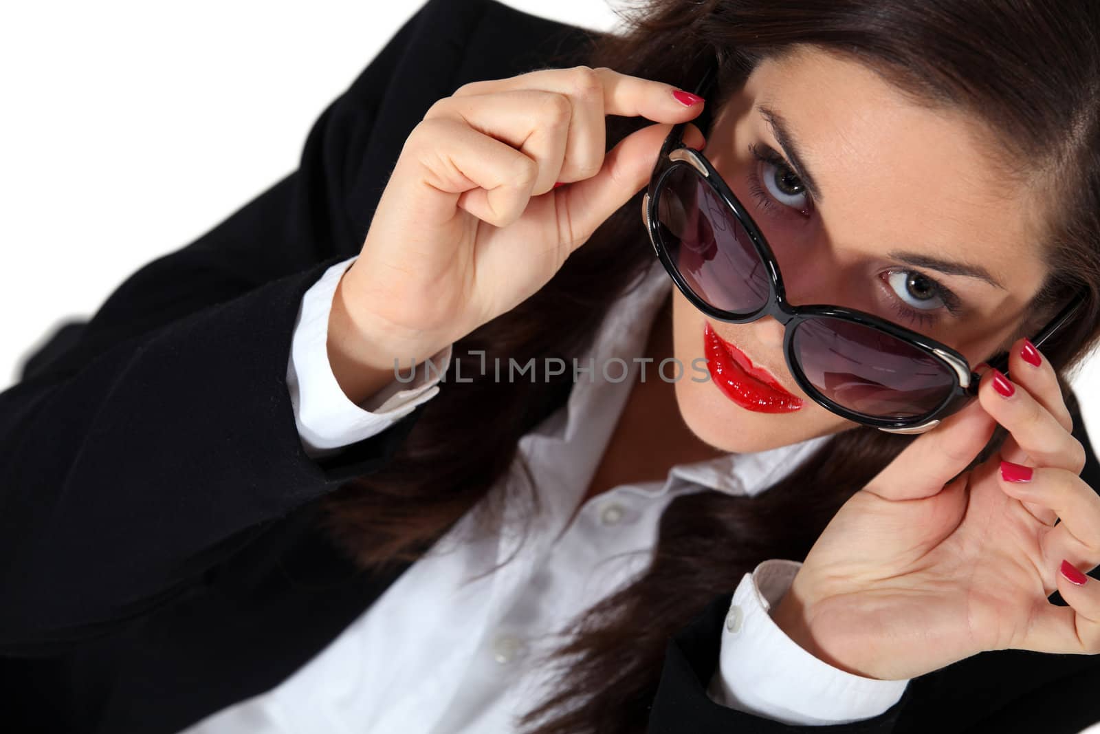 Businesswoman posing in sunglasses by phovoir