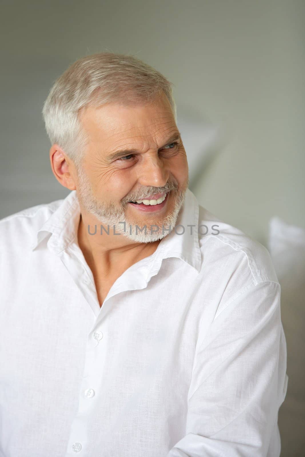 Smiling senior man by phovoir
