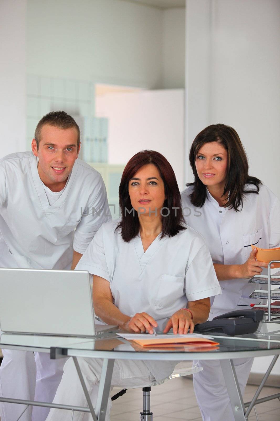 Dental team at a laptop by phovoir