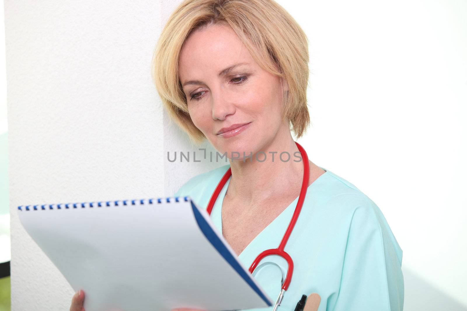 Nurse looking at chart by phovoir