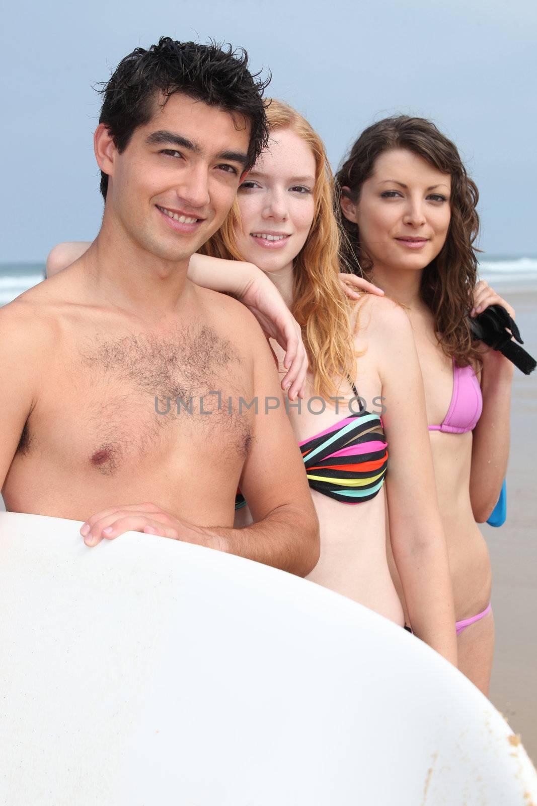 Three teenage friends at the beach by phovoir