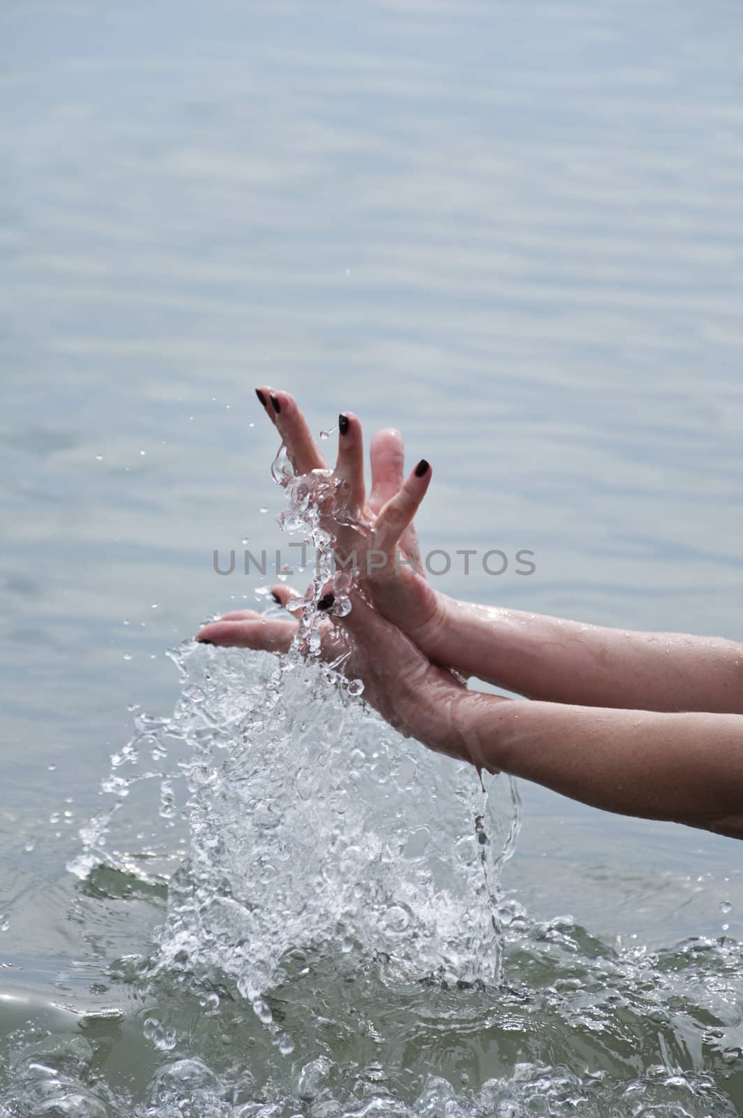 Women's hand with a spray of water