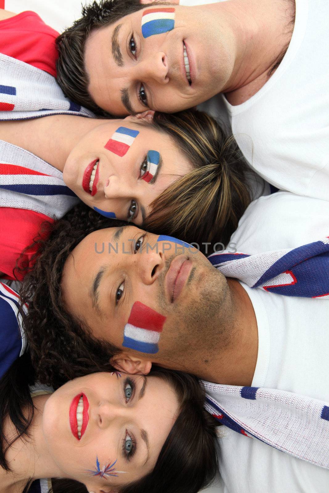 Four French football supporter laying together