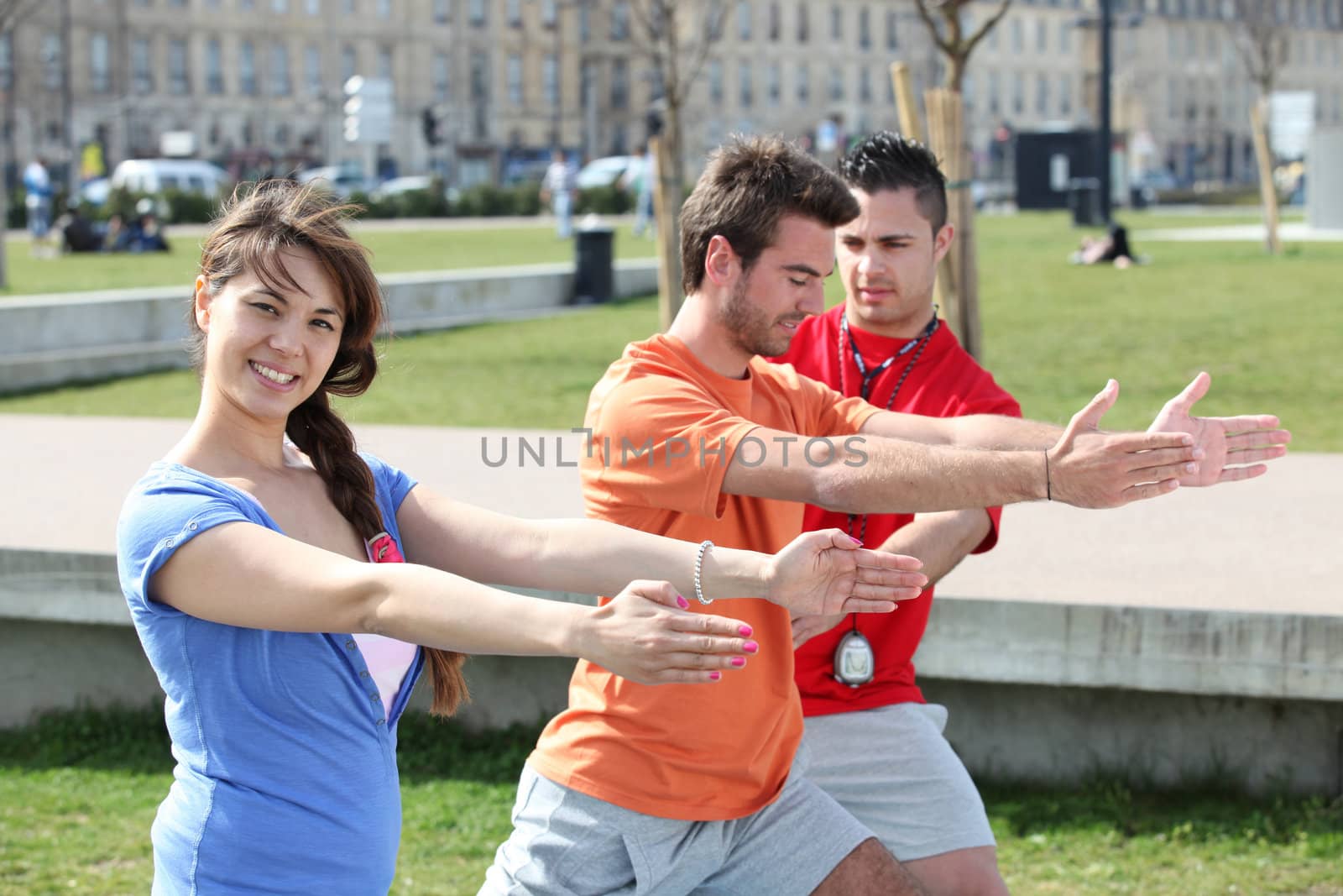 people doing stretching in a park by phovoir