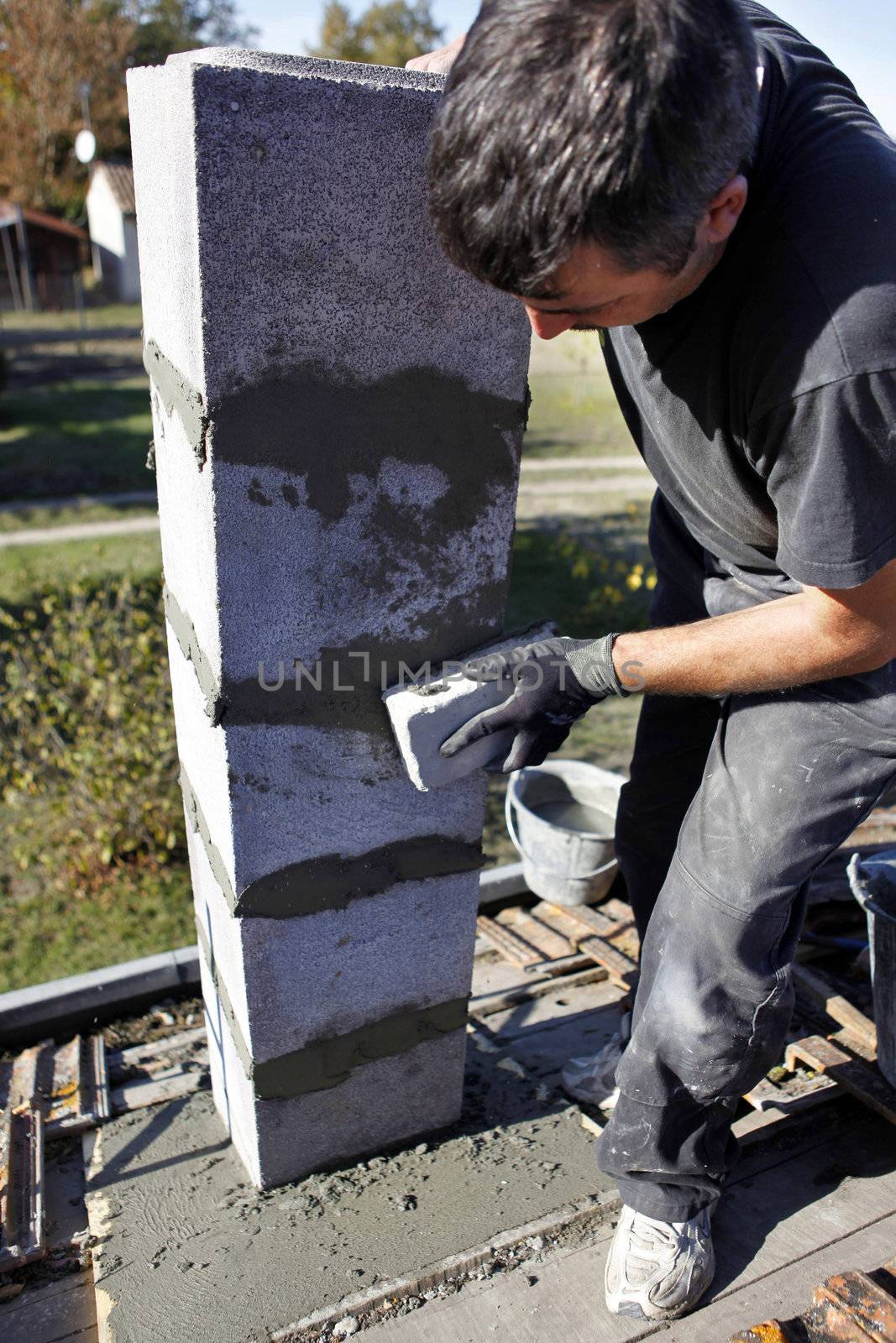 Workman erecting a stone slab