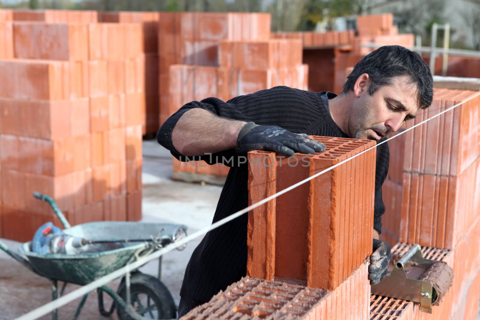 Worker building a wall