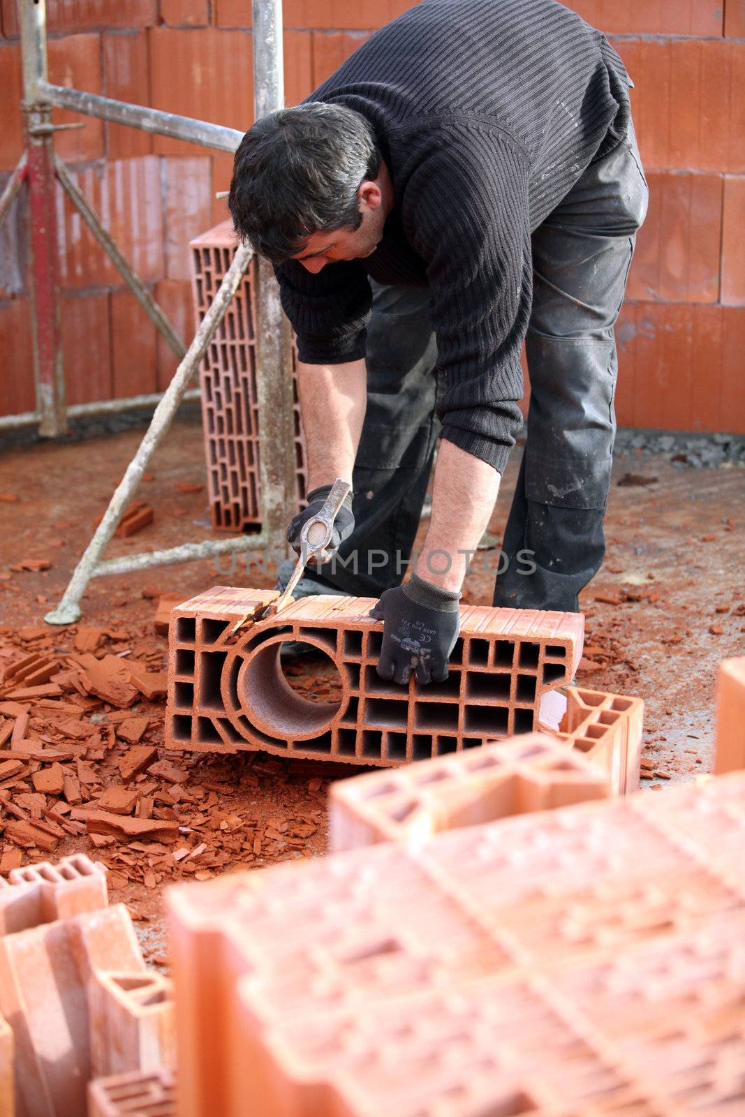Workman sculpting a brick