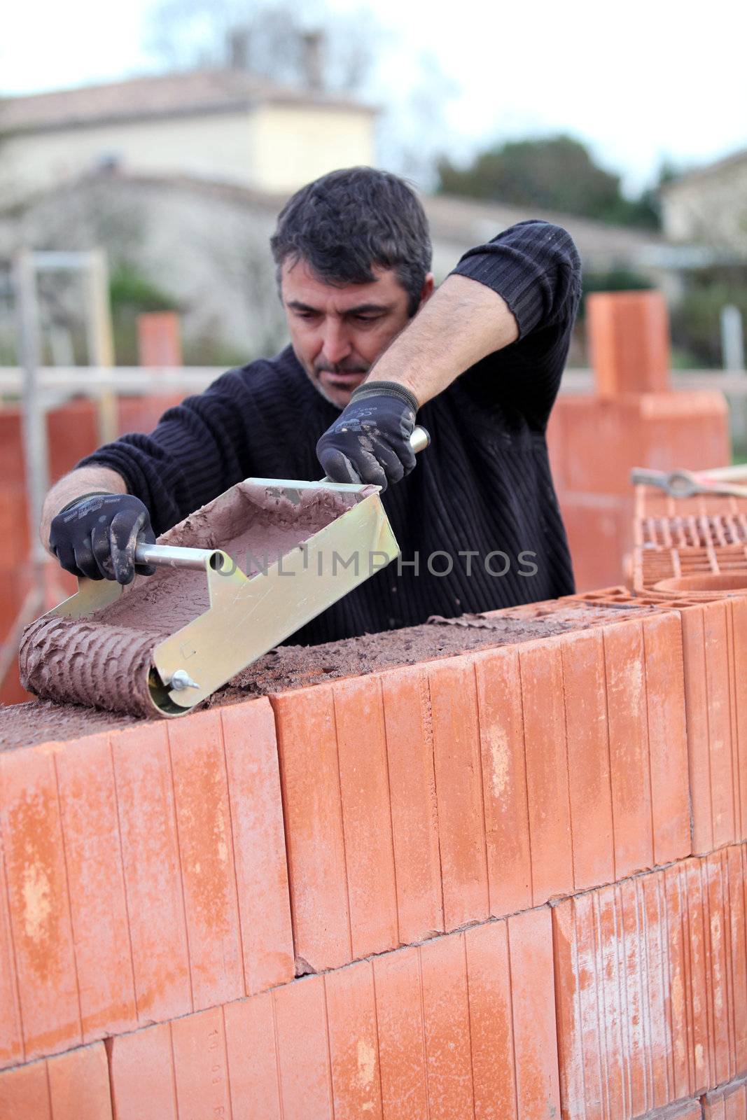 Builder laying blocks