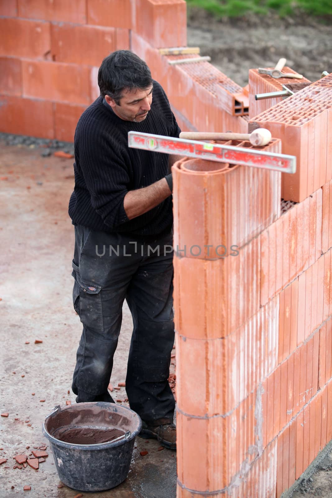 Mason working on site alone by phovoir