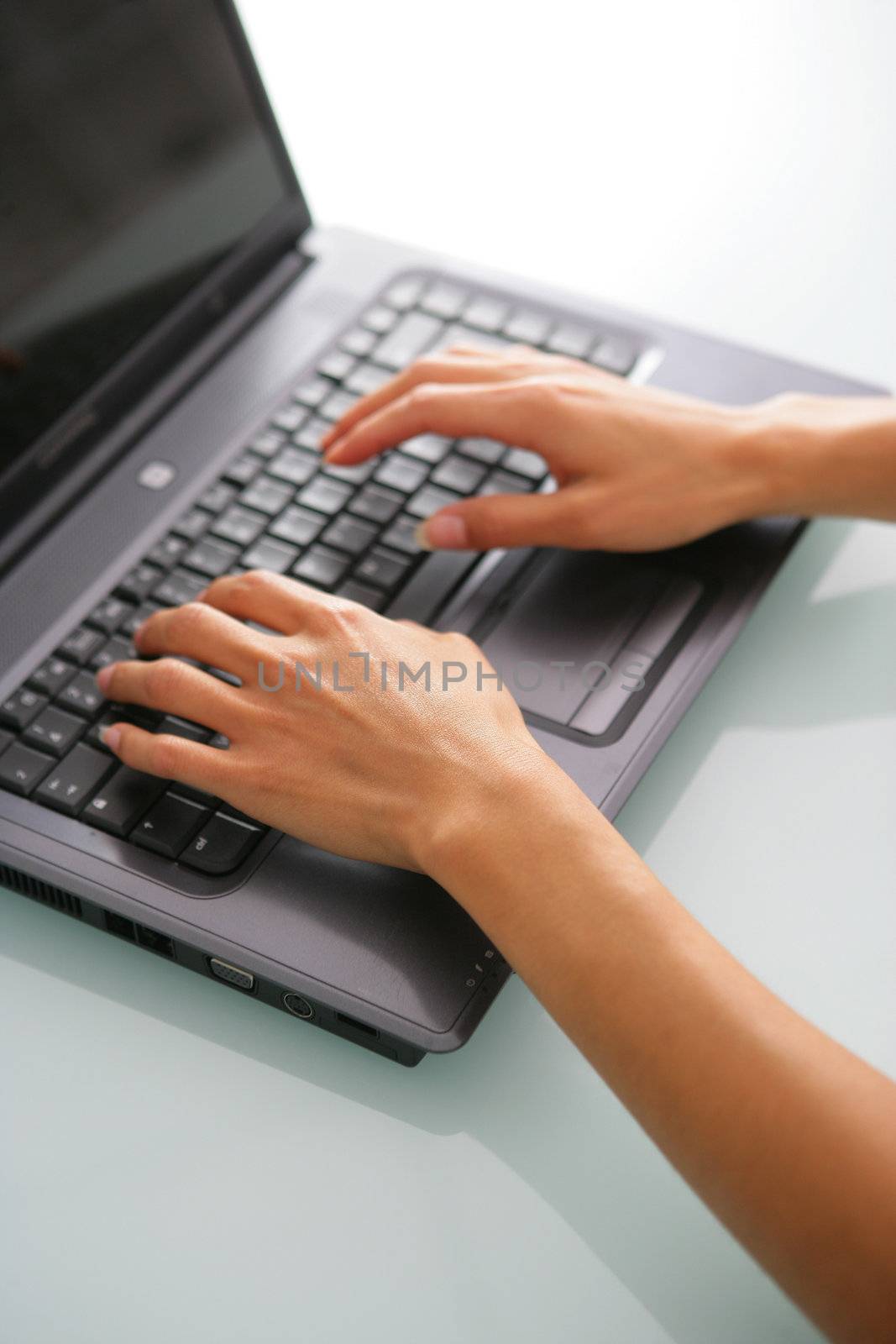 Close-up of woman typing on keyboard by phovoir