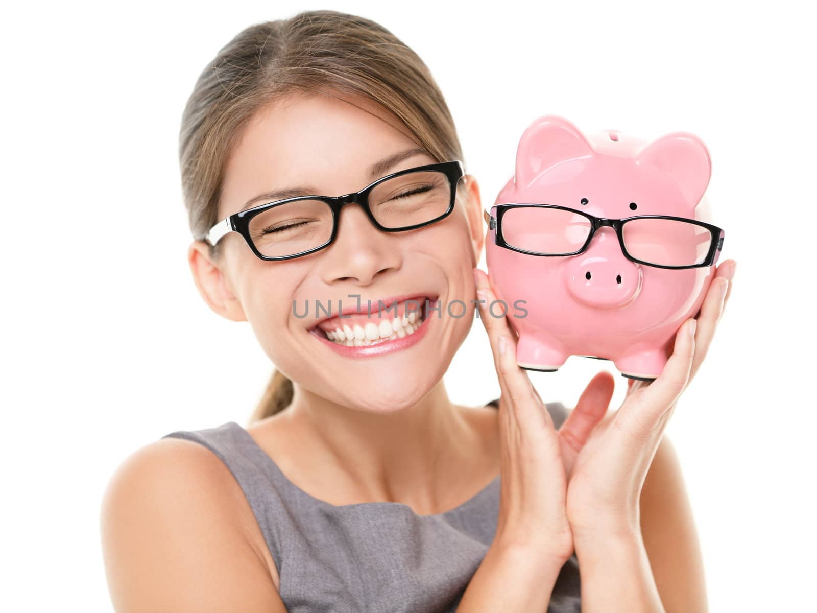 Glasses eyewear savings piggybank. Woman happy excited over saving money buying glasses. Young beautiful multiracial Caucasian / Chinese Asian woman isolated on white background.