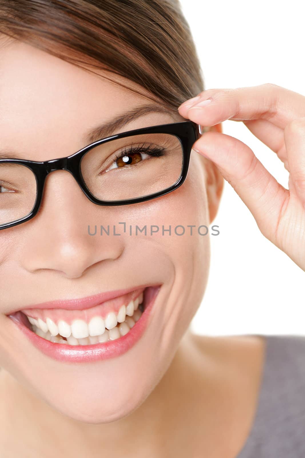 Glasses woman showing eyewear smiling happy holding glasses frame. Closeup of young multiethnic mixed race asian caucasian woman smiling. White background.