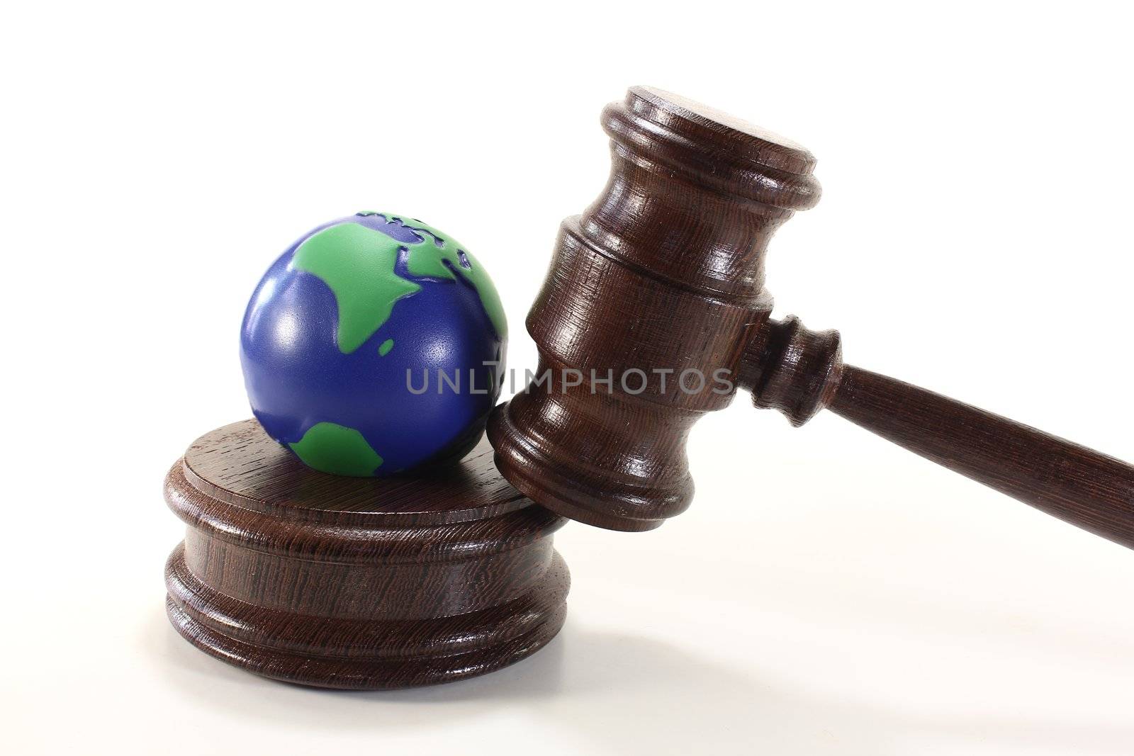 brown judges Gavel with colored globe on a light background