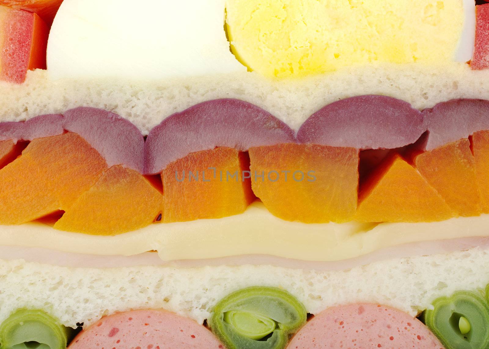 Cross section close-up of a multilayered sandwich with various indegredients.