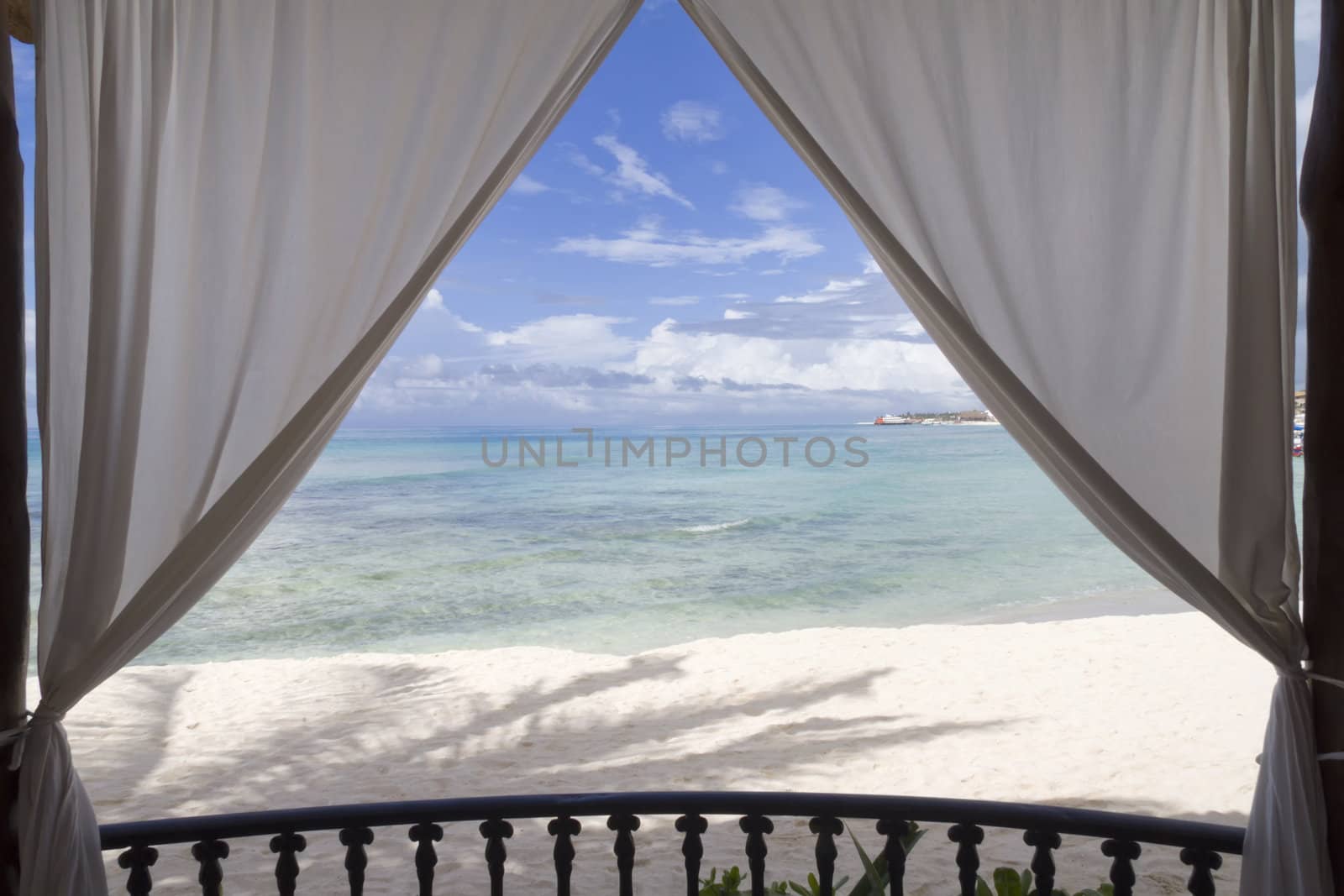 A framed view of the beach and tropical ocean