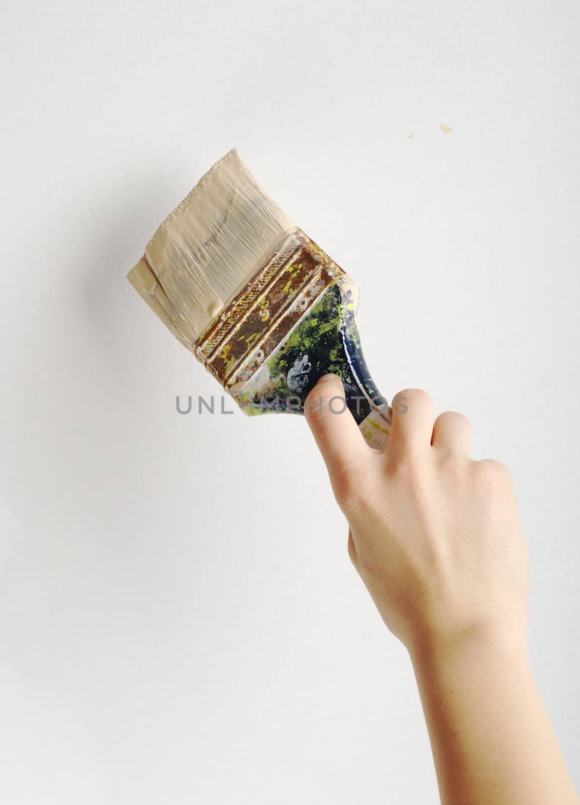 Hand painting with brush on white wall