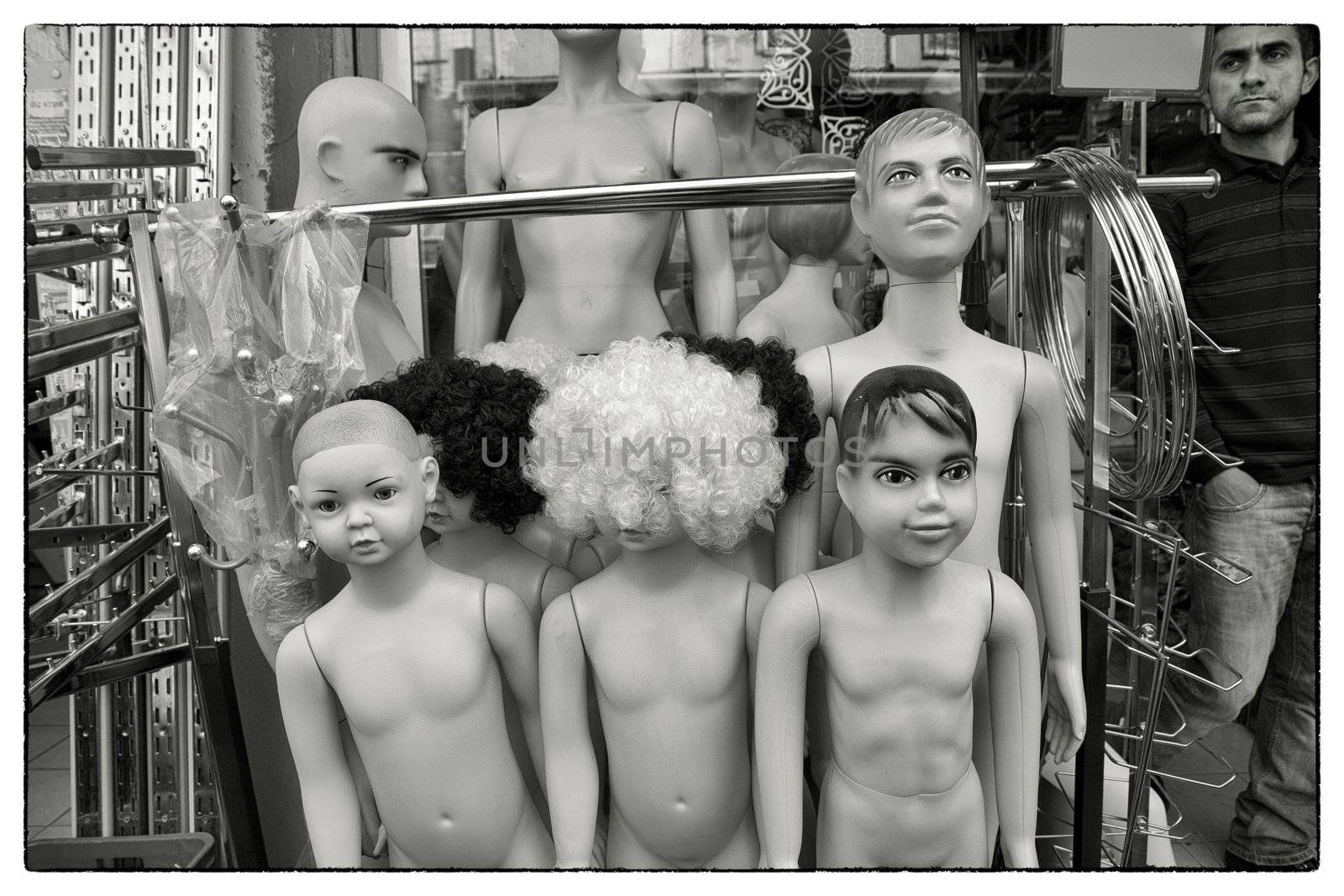UNDRESSED MANNEQUINS, ISTANBUL, TURKEY, APRIL 12, 2012: Shopkeeper outside his store with mannequin dolls and shop equipment waiting for customers.