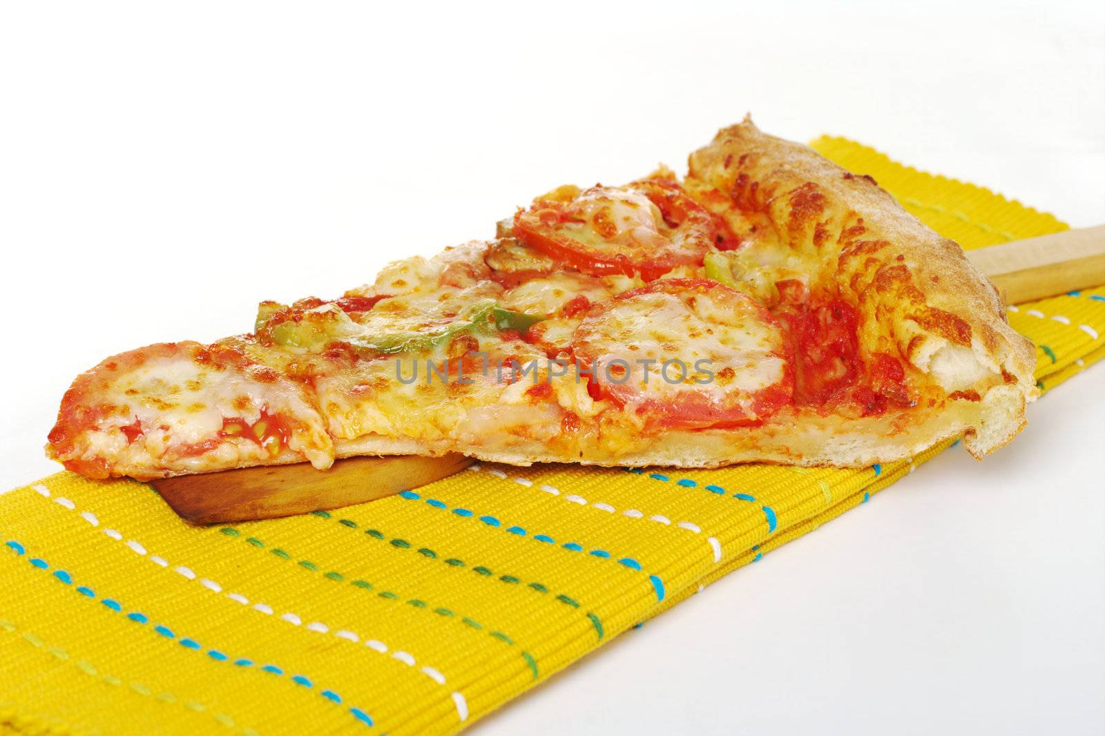 Vegetarian pizza slice on wooden spatula and yellow table mat on white background (Selective Focus) 