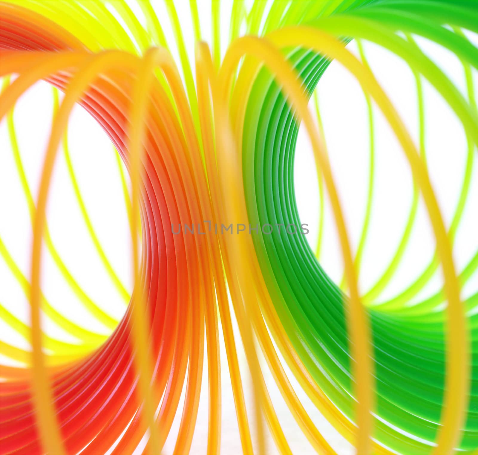 The colorful rings of a toy forming a circular tunnel (Selective Focus, Focus on the middle where the rings meet)