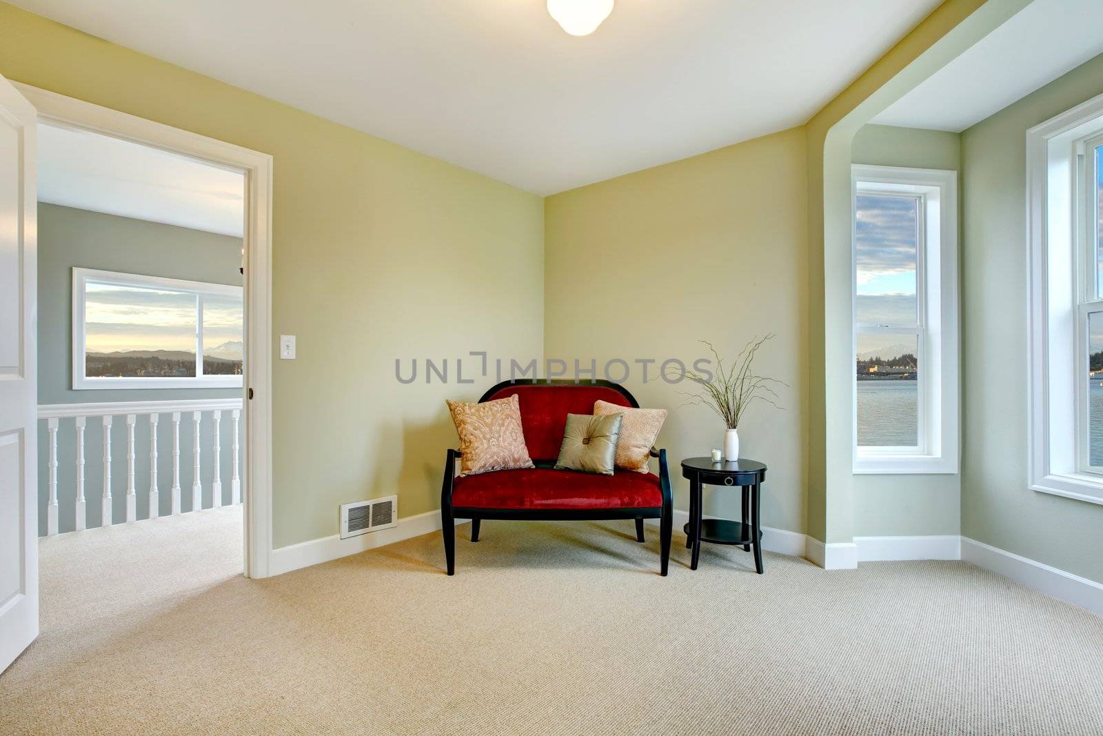 Newly remodeled clean bedroom with bench and stairicase.