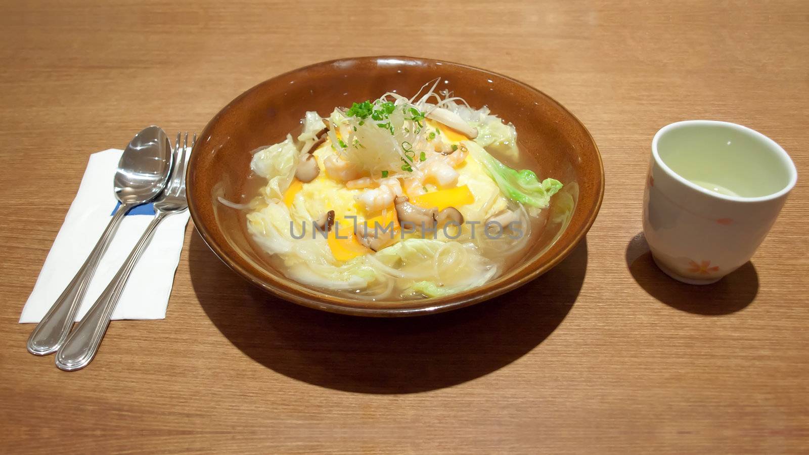 Omelette rice(omurice or oromuraisu) in japanese soup with shiitake mushroom, shrimp and vegetable, japanese food