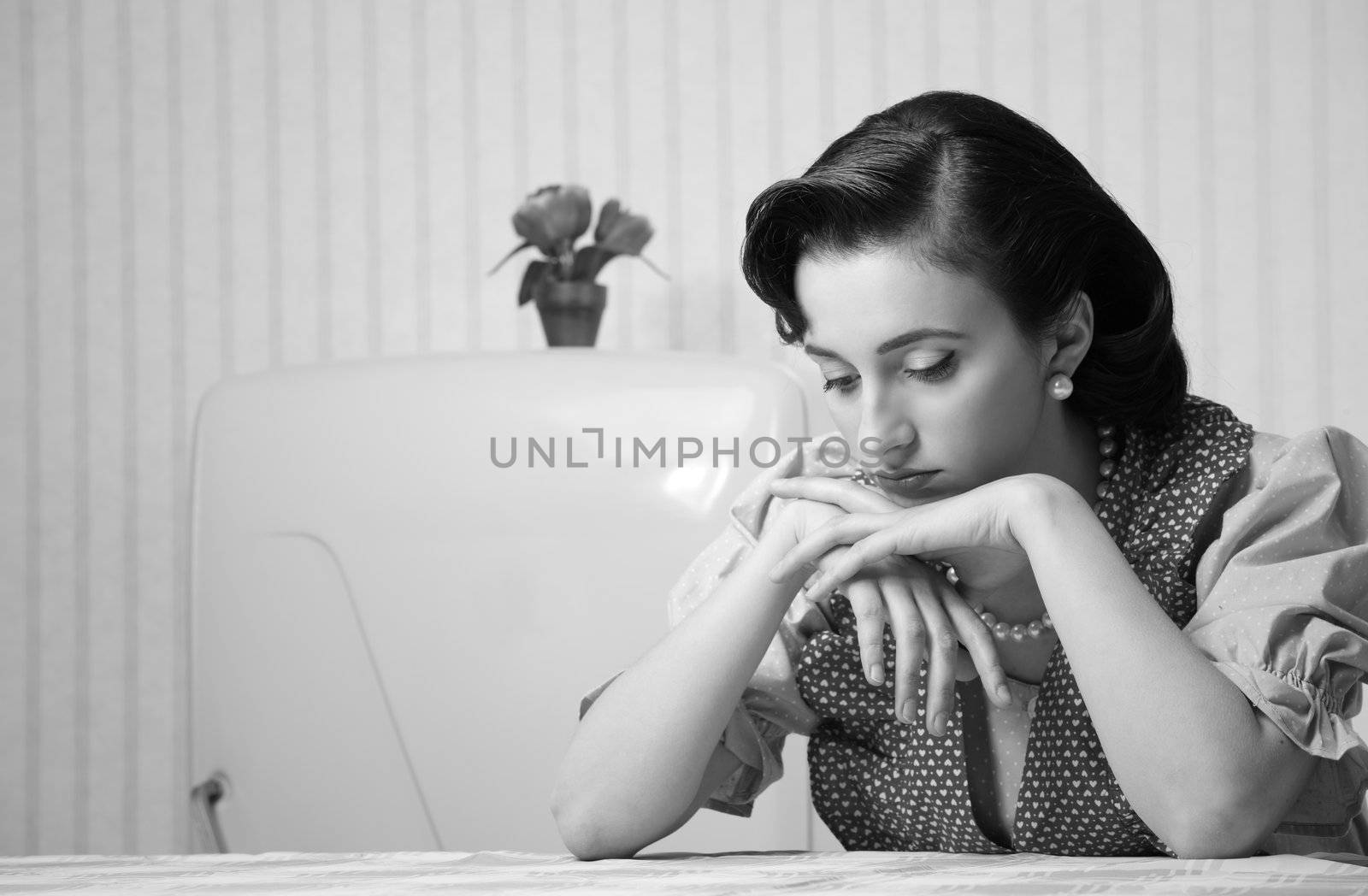 Portrait of a depressed housewife in the kitchen