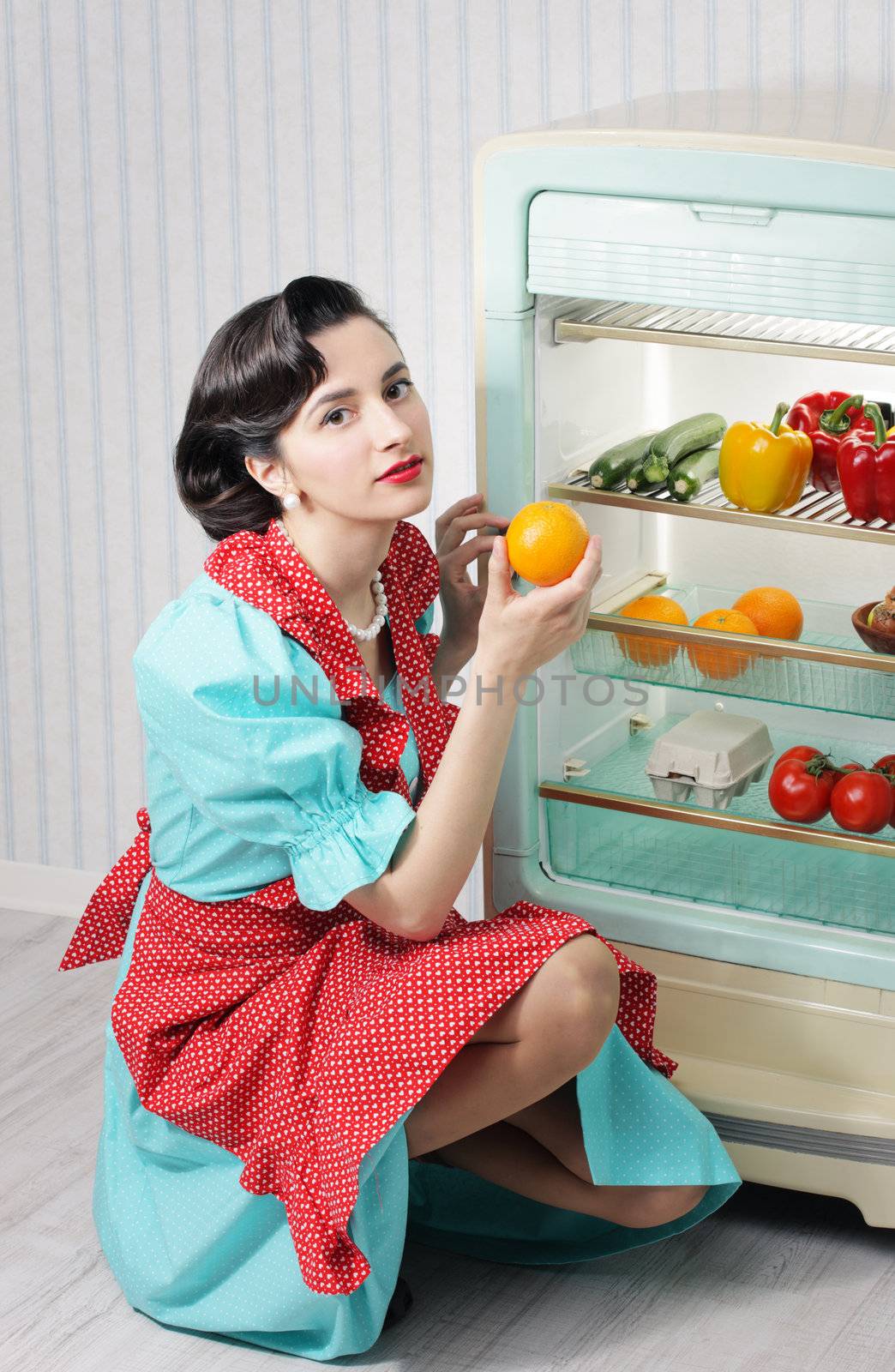 Beautiful woman posing with an open refrigerator
