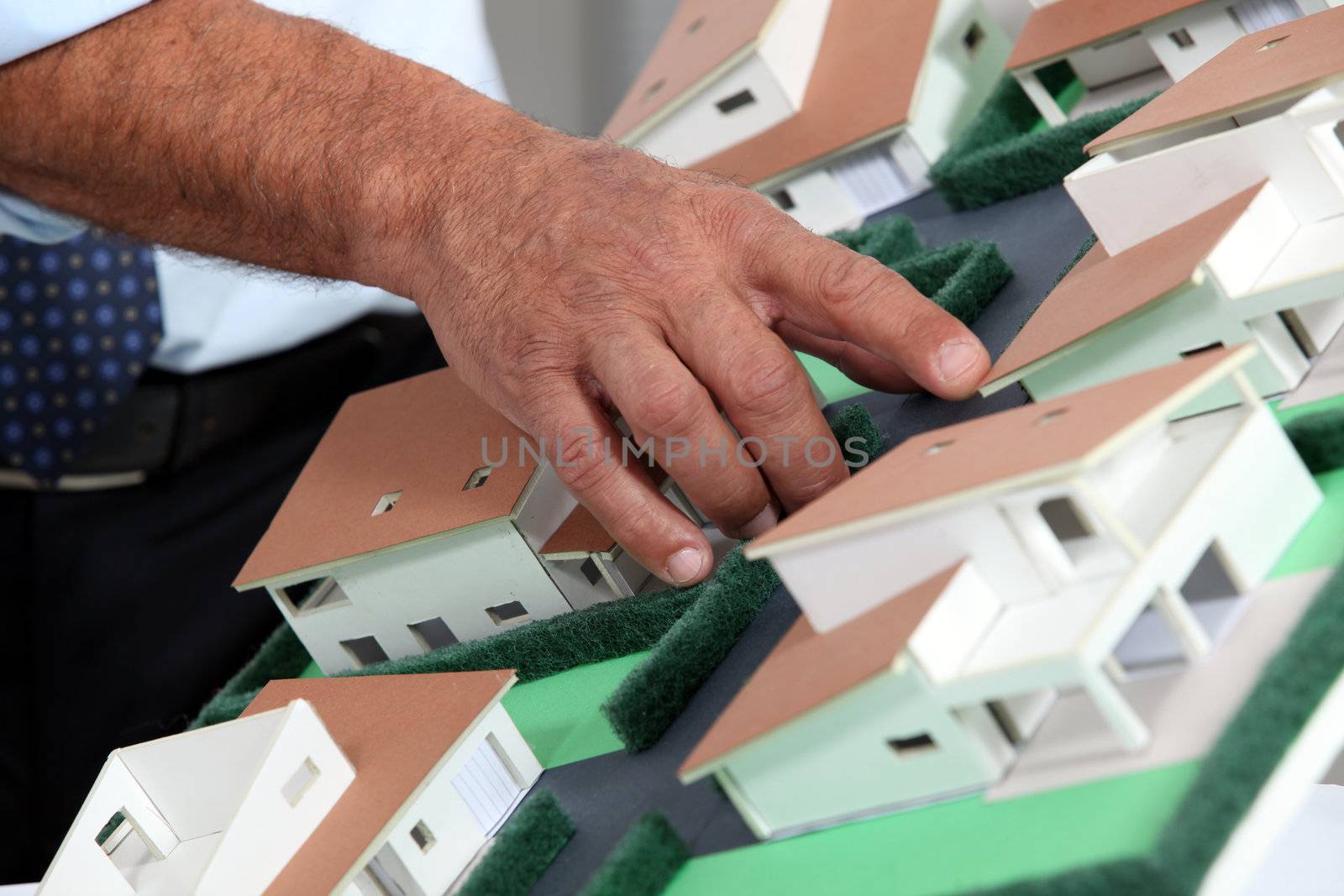 Man with a model of a housing estate by phovoir