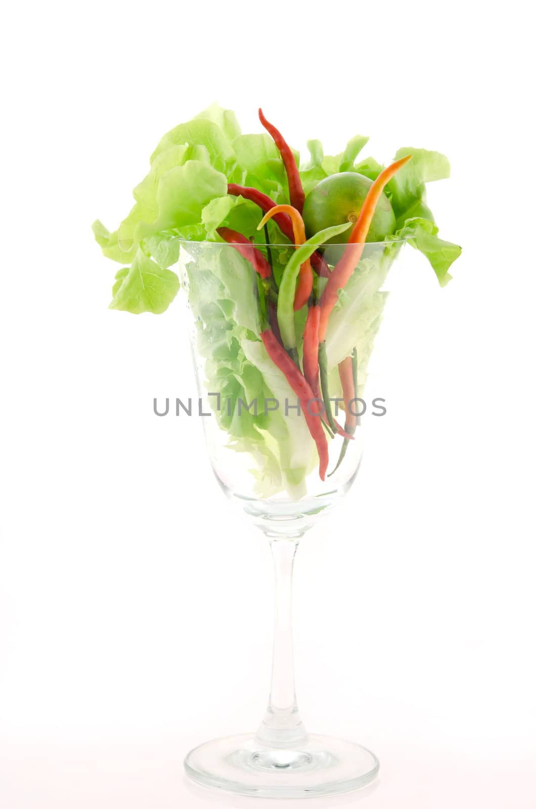 fresh chili , lime and lettuce  in glass on white background