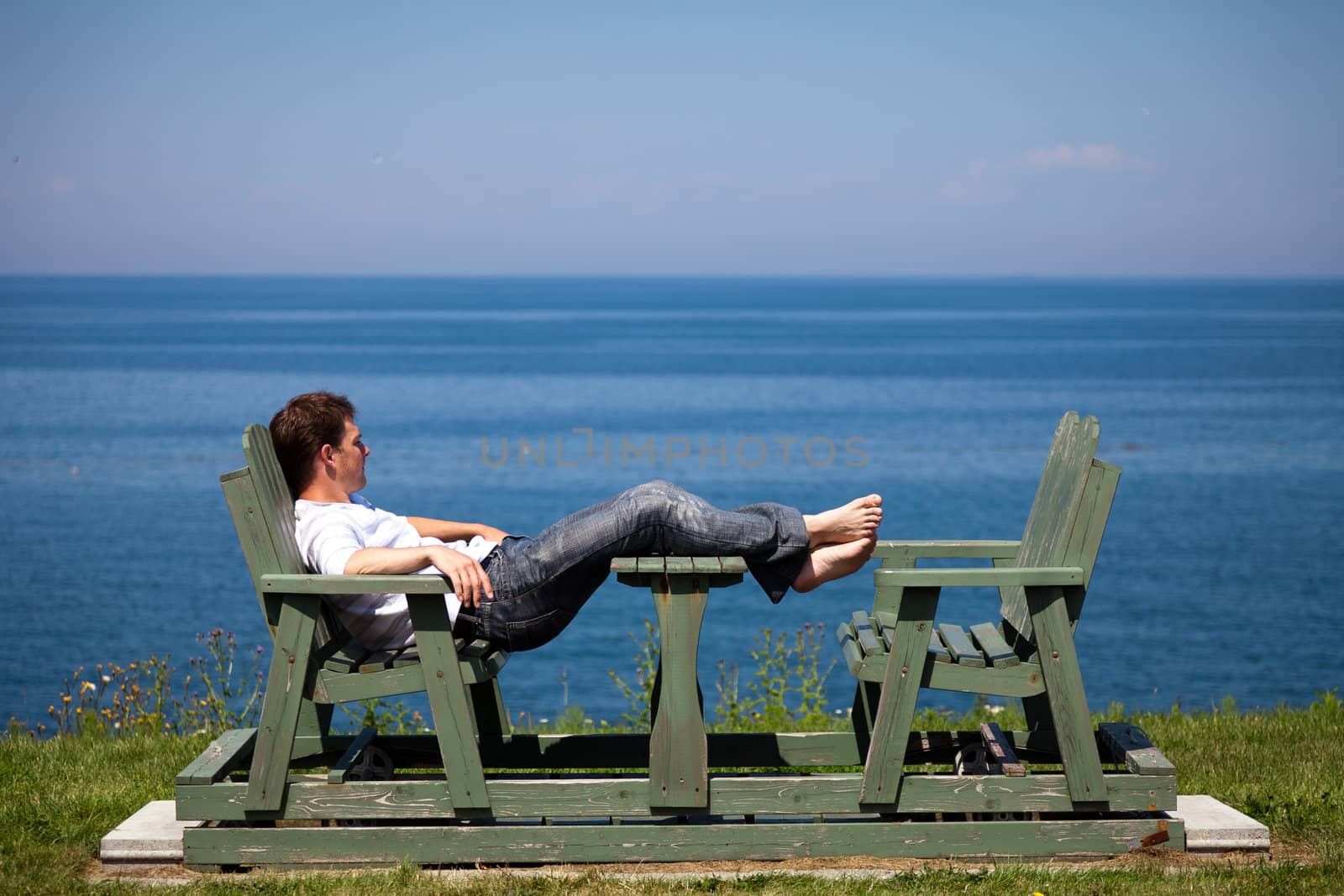 Man alone on a bench in vacation